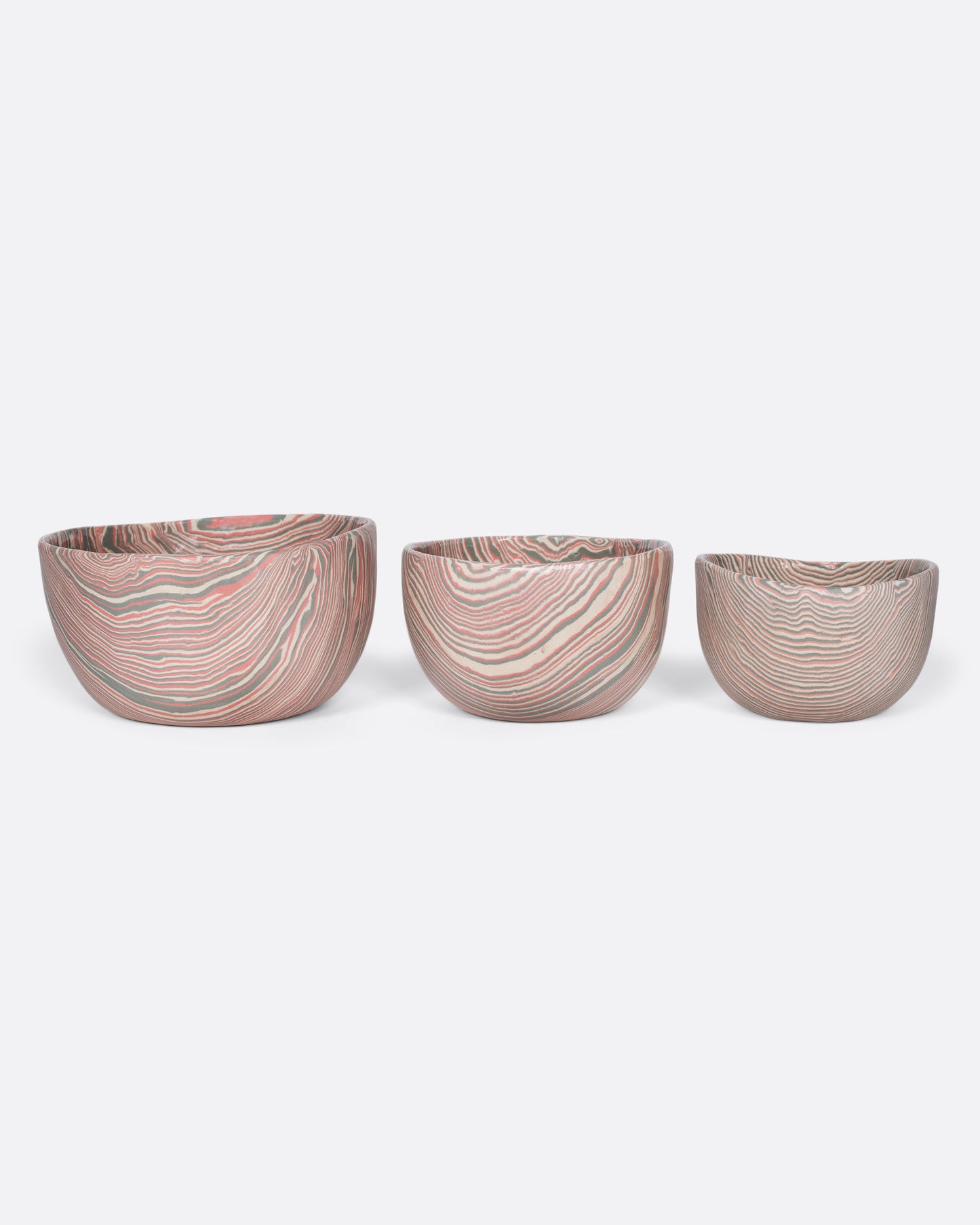 These small-batch ceramic bowls are made with a traditional Japanese nerikomi technique that creates an intricate, marbled design by layering and compressing clay. This timeless style feels plucked from desert sandstone with flowing hues of pink, white, and grey. Available in small, medium, and large sizes.