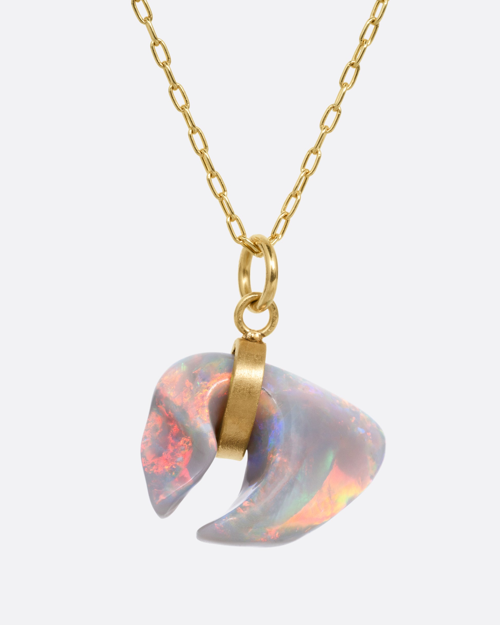 A yellow gold cable chain with a claw shaped Australian opal belted in gold, shown from the front.