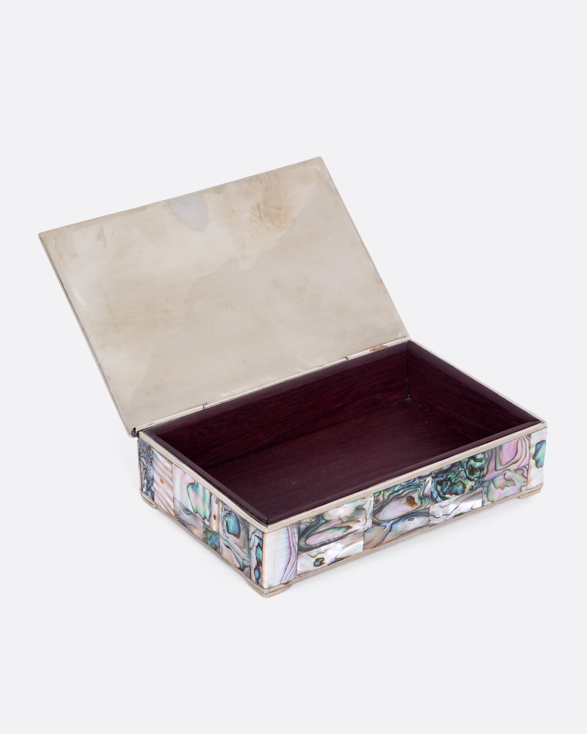 An alpaca silver box with abalone inlay and a rosewood interior. Shown open.