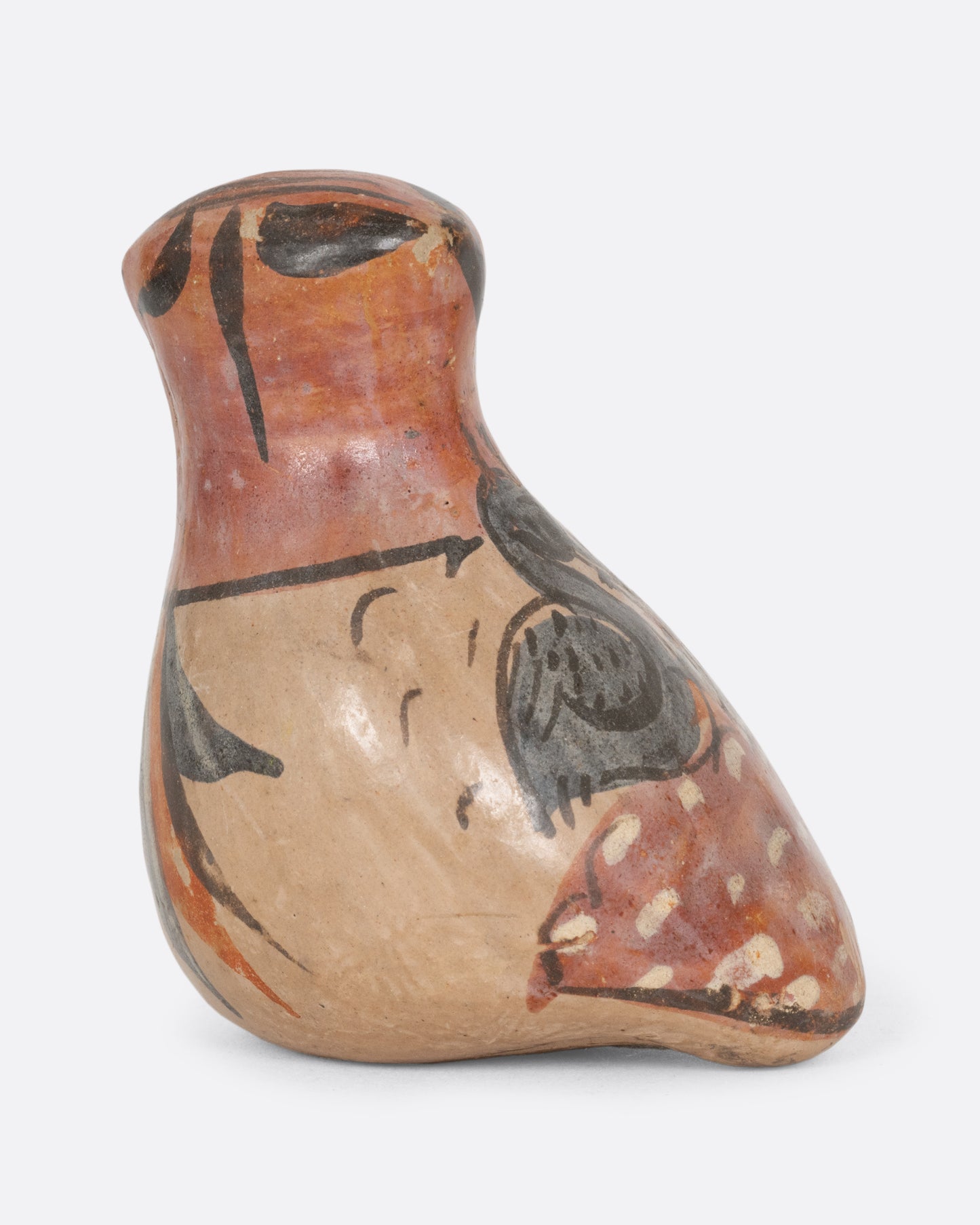 A hand painted tonala style owl figurine. Shown from the back.