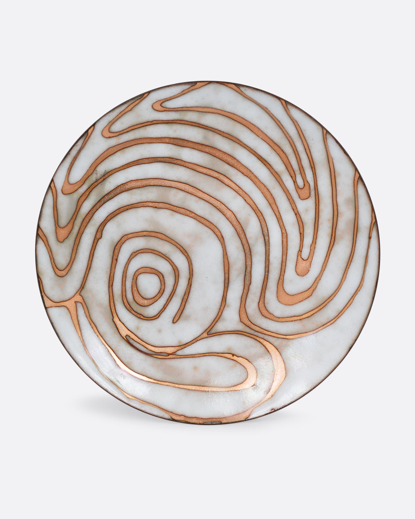 A metal plate with a golden swirl and white enamel. Shown from the front.