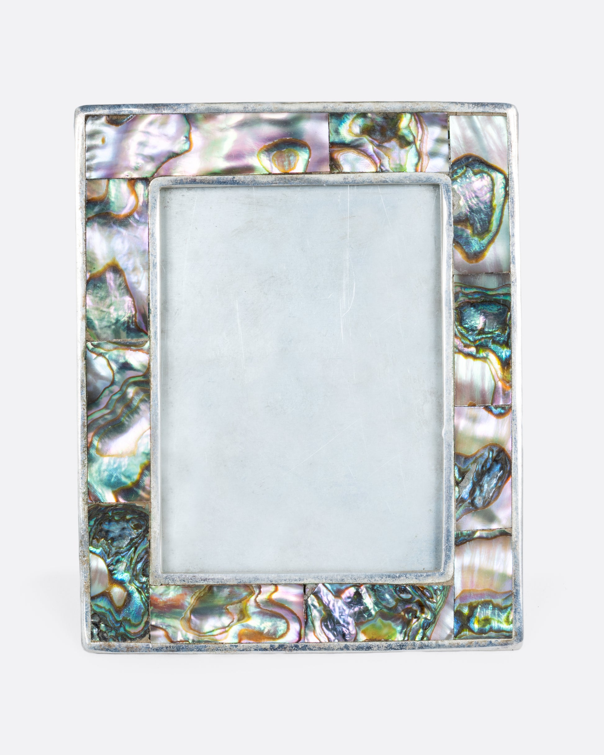 An alpaca silver rectangular faced frame with abalone inlay. Shown from the front.