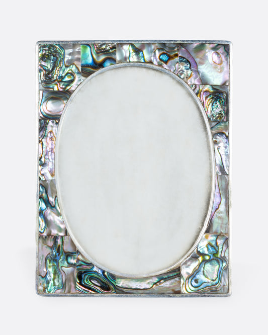 An alpaca silver oval faced frame with abalone inlay. Shown from the front.