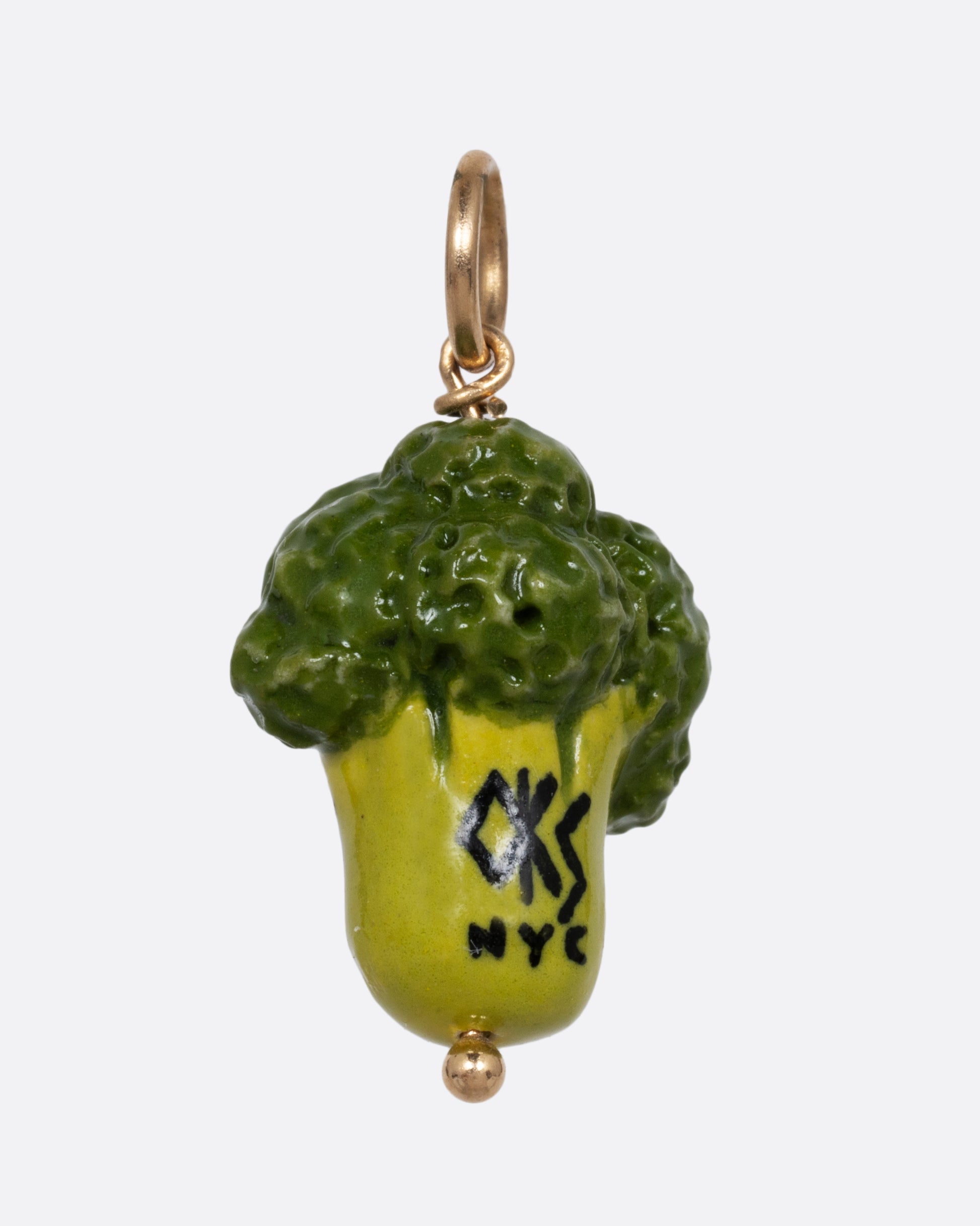 A green broccoli porcelain charm with a yellow gold bail. Shown from the back.