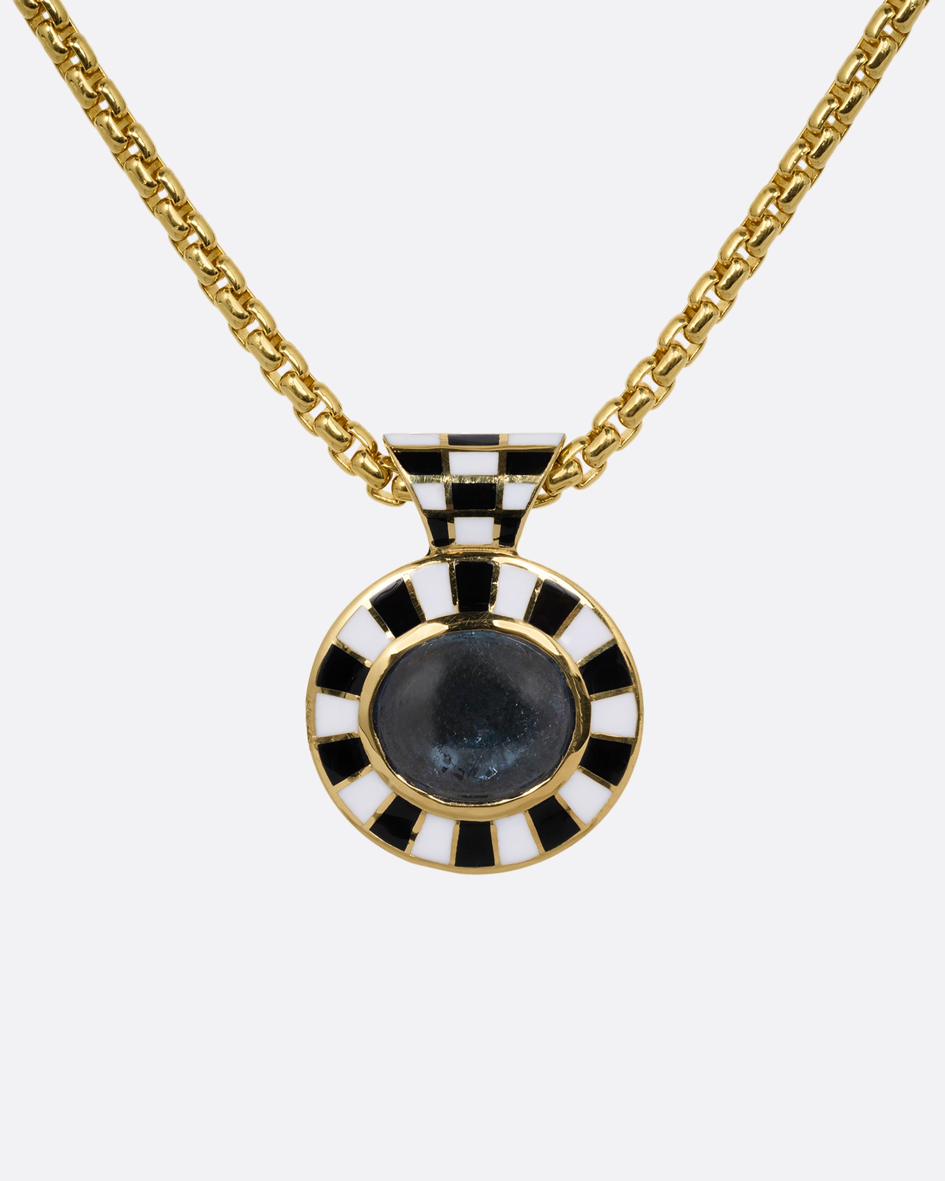 A tourmaline pendant with a black and white enamel checkerboard pattern on a box chain. Shown from the front.