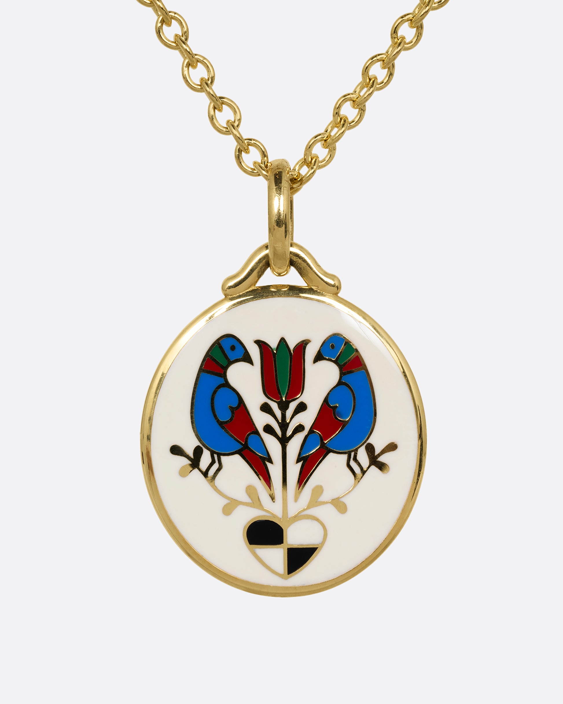 An enamel and yellow gold pendant with a pair of birds, a flower, and a heart on a  cable chain. Shown from the front.