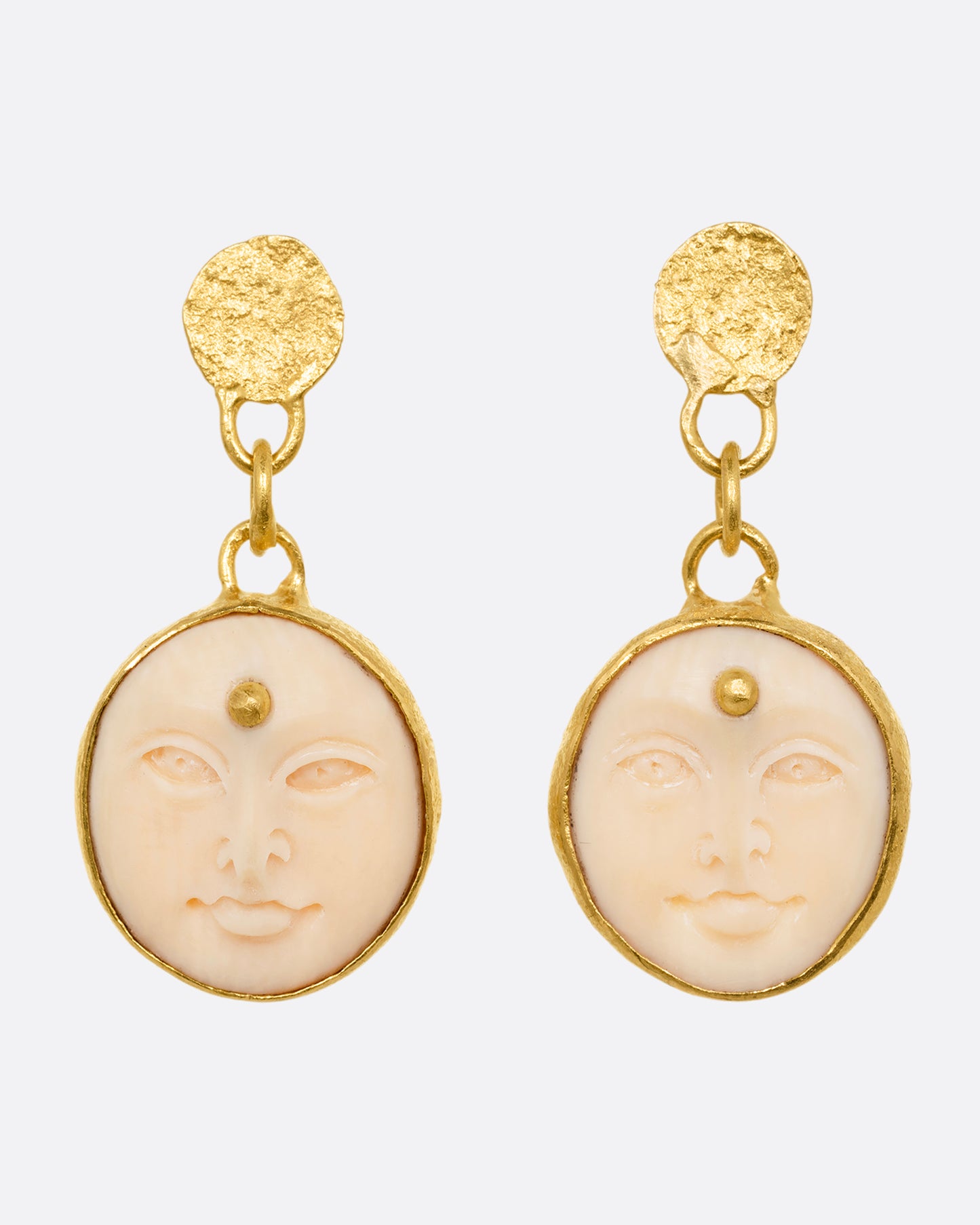 yellow gold carved bone moon face earrings shown from the front