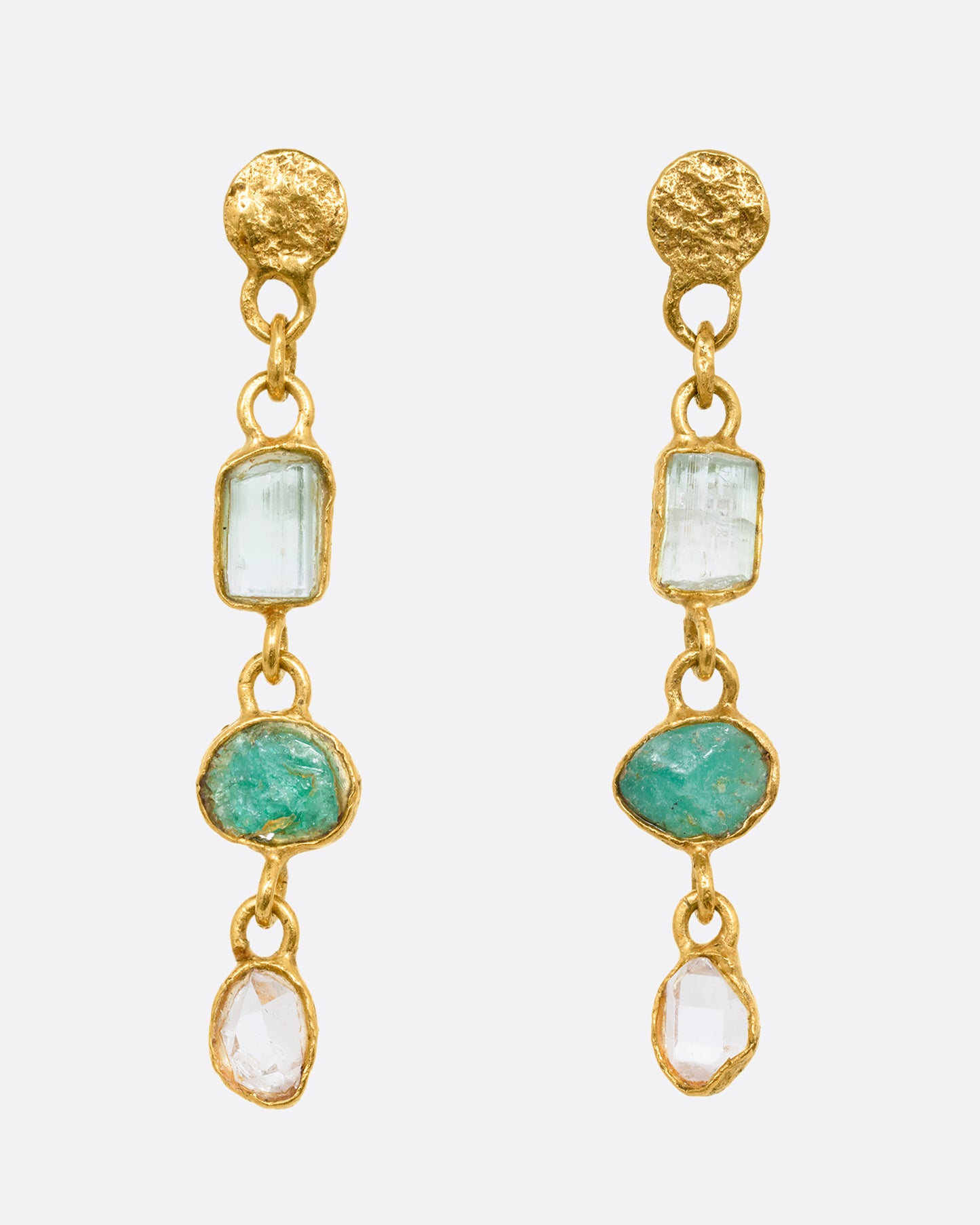 A pair of high carat yellow gold three tier earrings with tourmalines, emeralds and herkimer diamonds. Shown from the front.