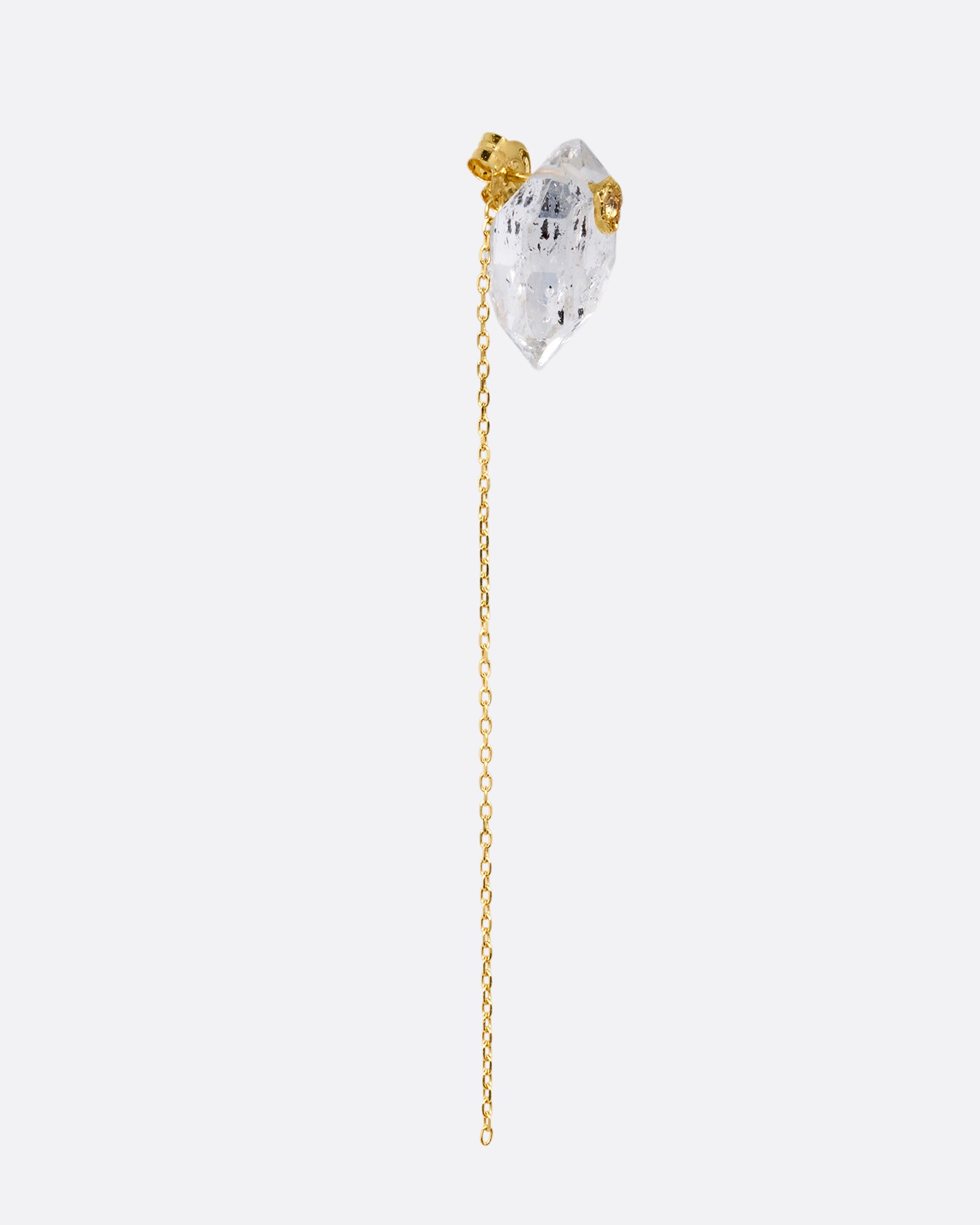 A pin and chain earring with a quartz and cable chain. Shown from the side.