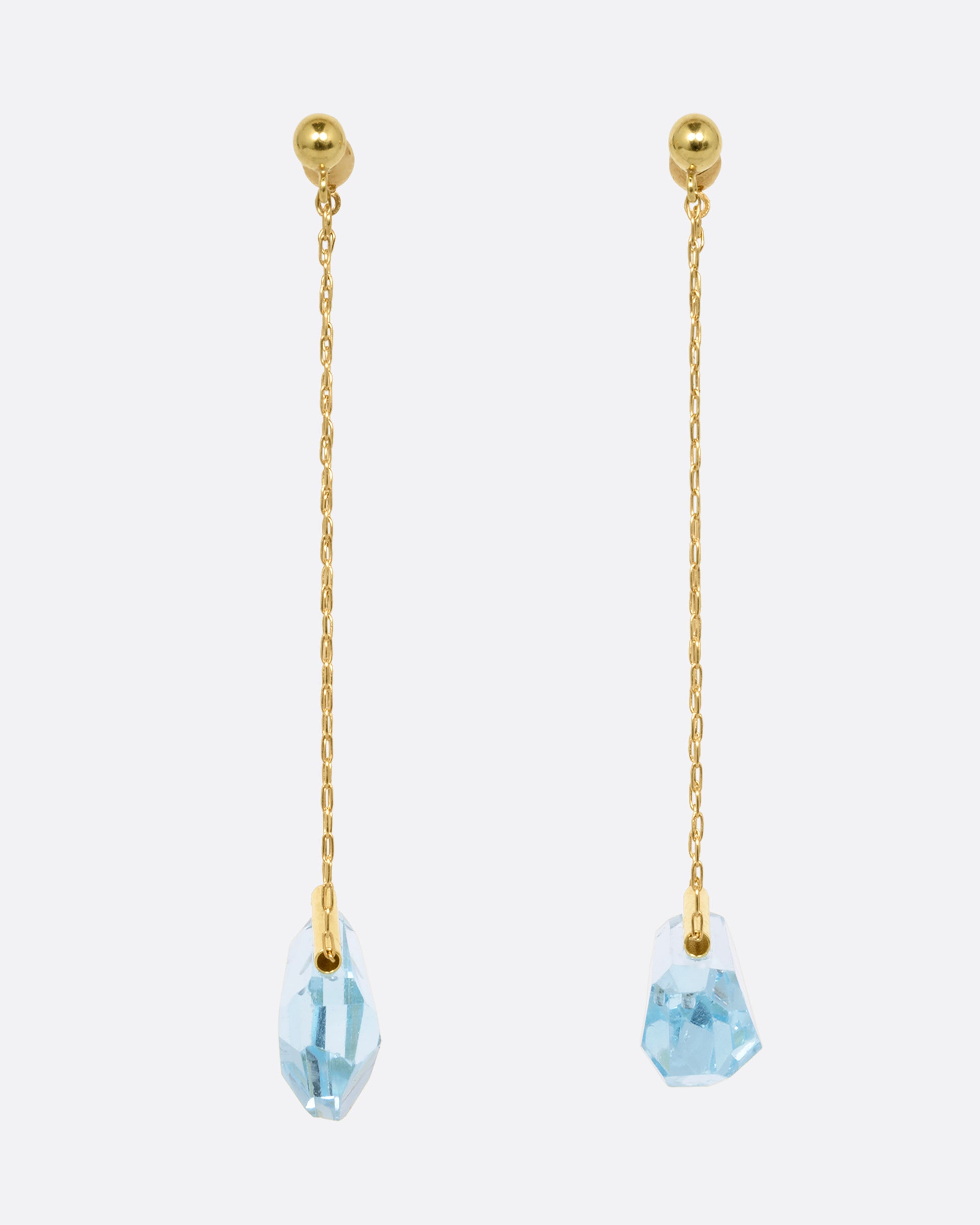 A pair of yellow gold chain earrings with free form blue topaz. Shown from the front.