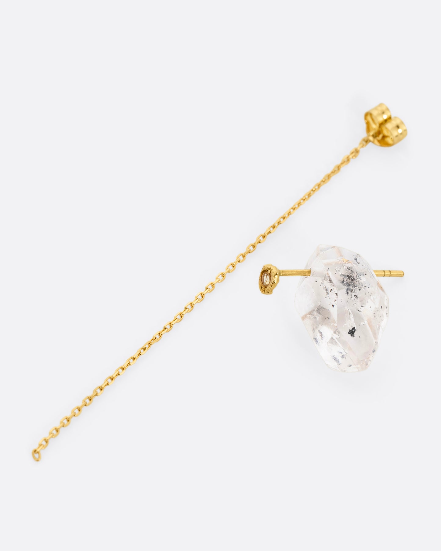 A pin and chain earring with a quartz and cable chain. Shown open from the side.