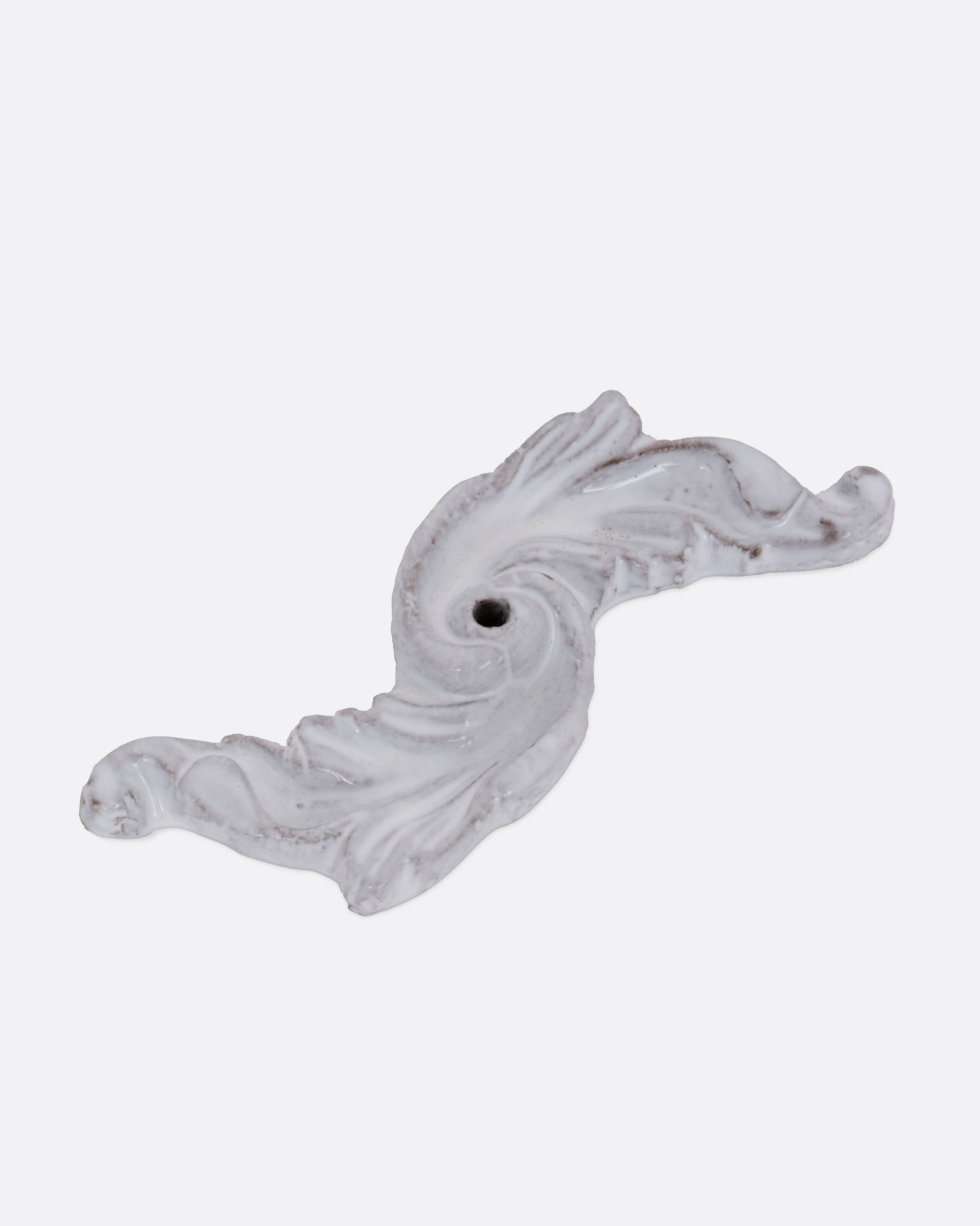 A white ceramic floral shaped incense burner, shown from the top.