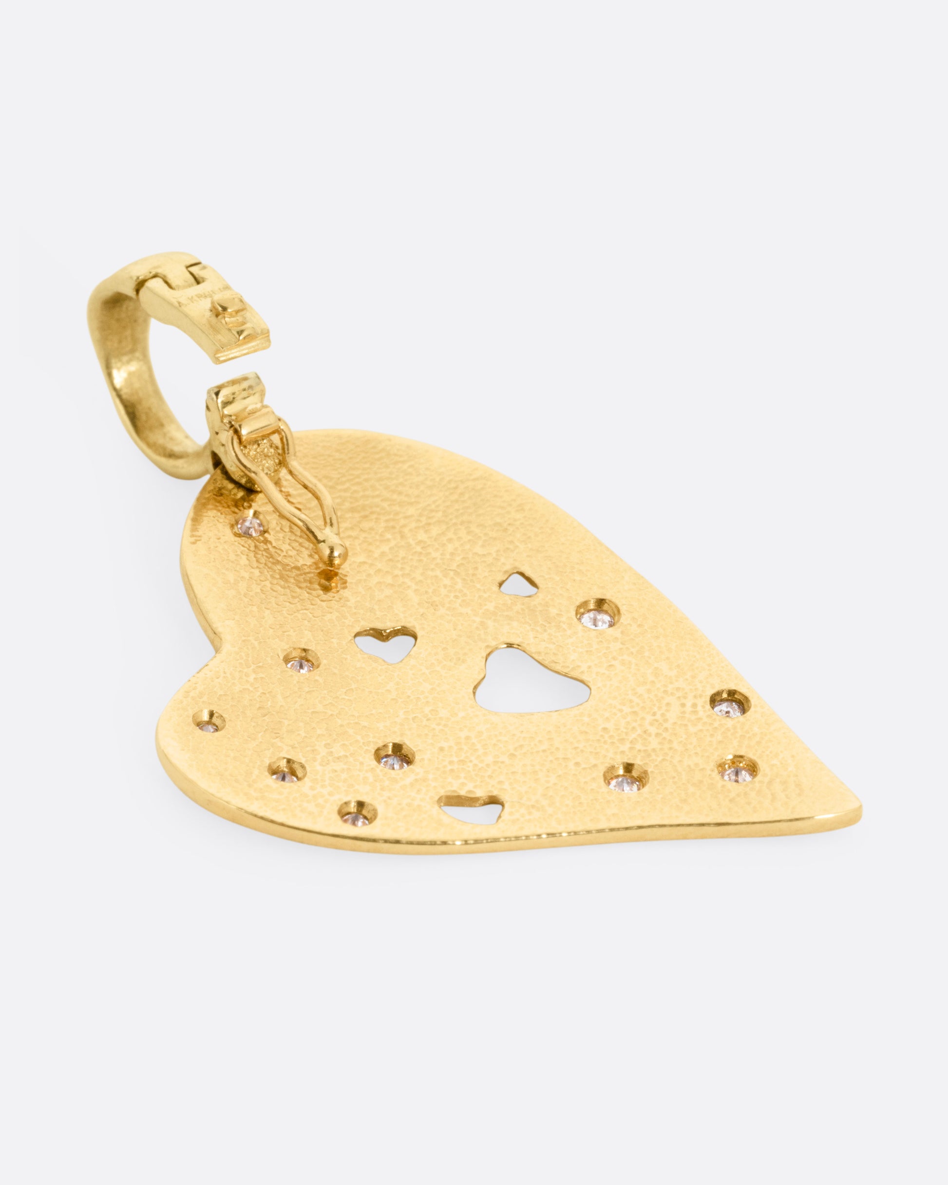 A yellow gold heart shaped pendant with diamond accents. Shown from the back.