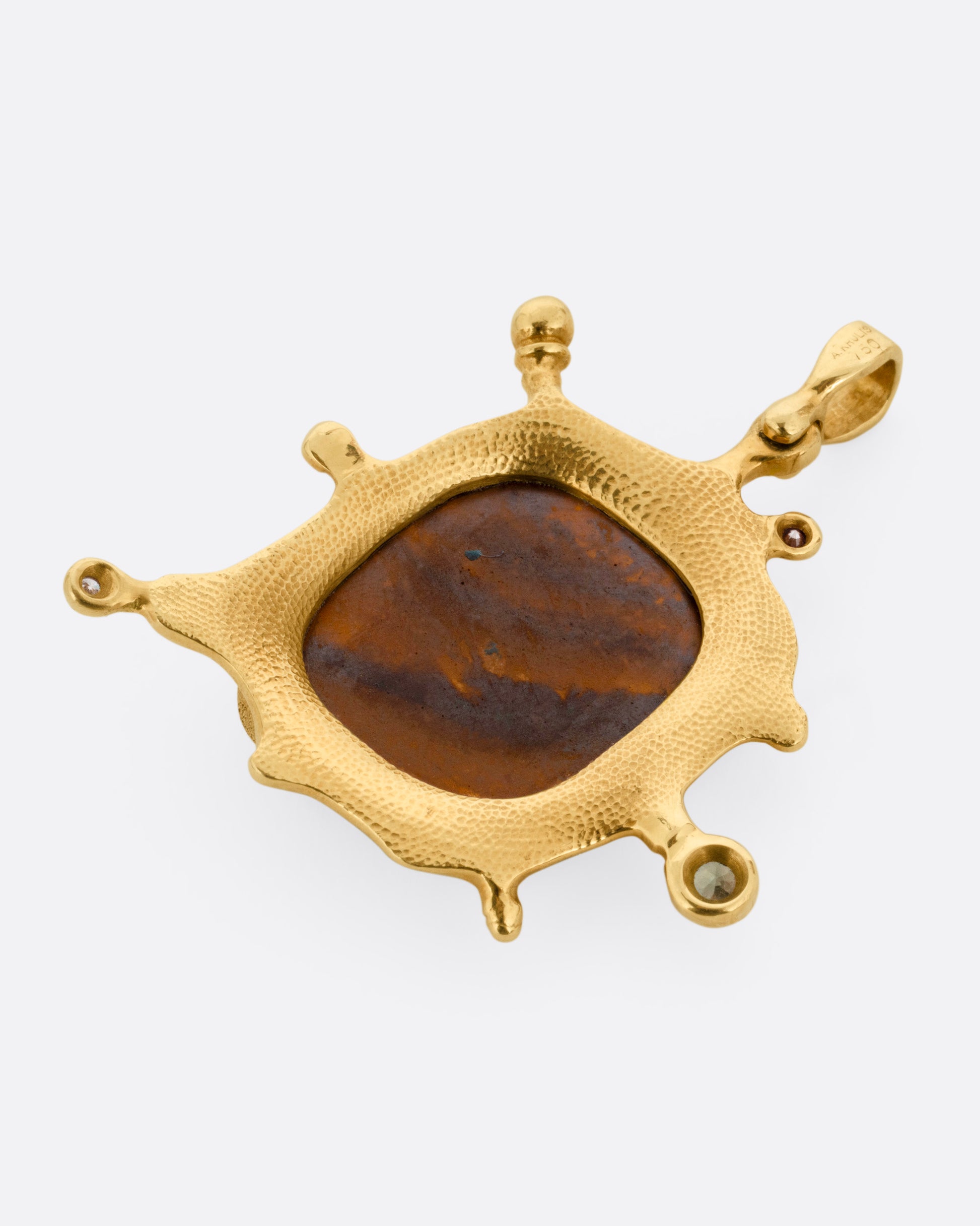A yellow gold pendant with a boulder opal and diamonds and sapphires along its edges, shown from the back.