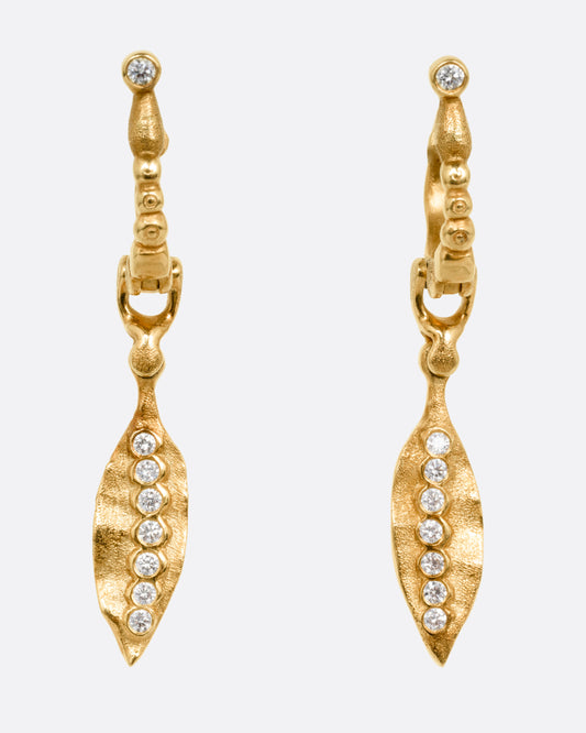 A pair of gold drop earrings with dangling leaves and diamond accents, shown from the front.