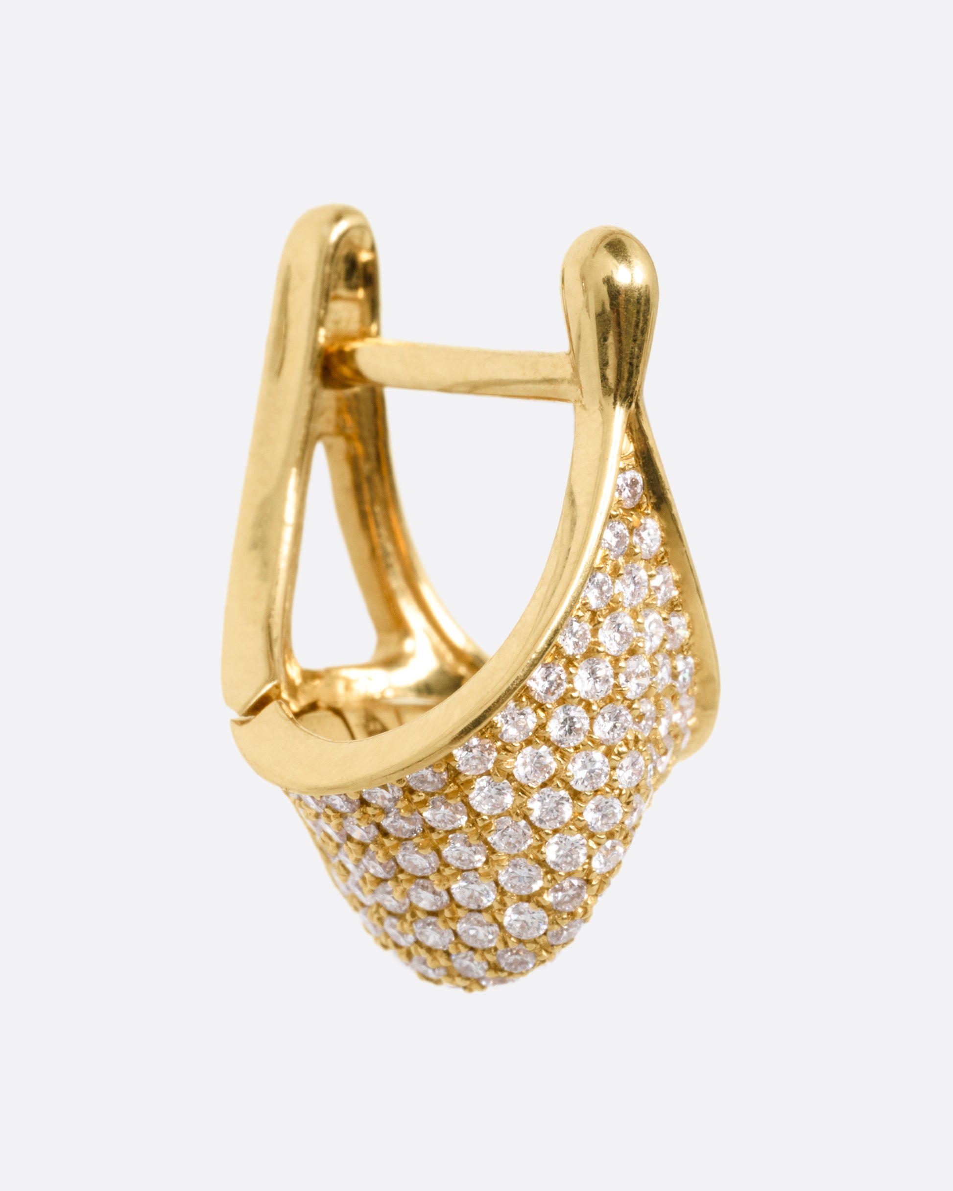 A yellow gold angular hoop earring covered in pave diamonds, shown from the side.
