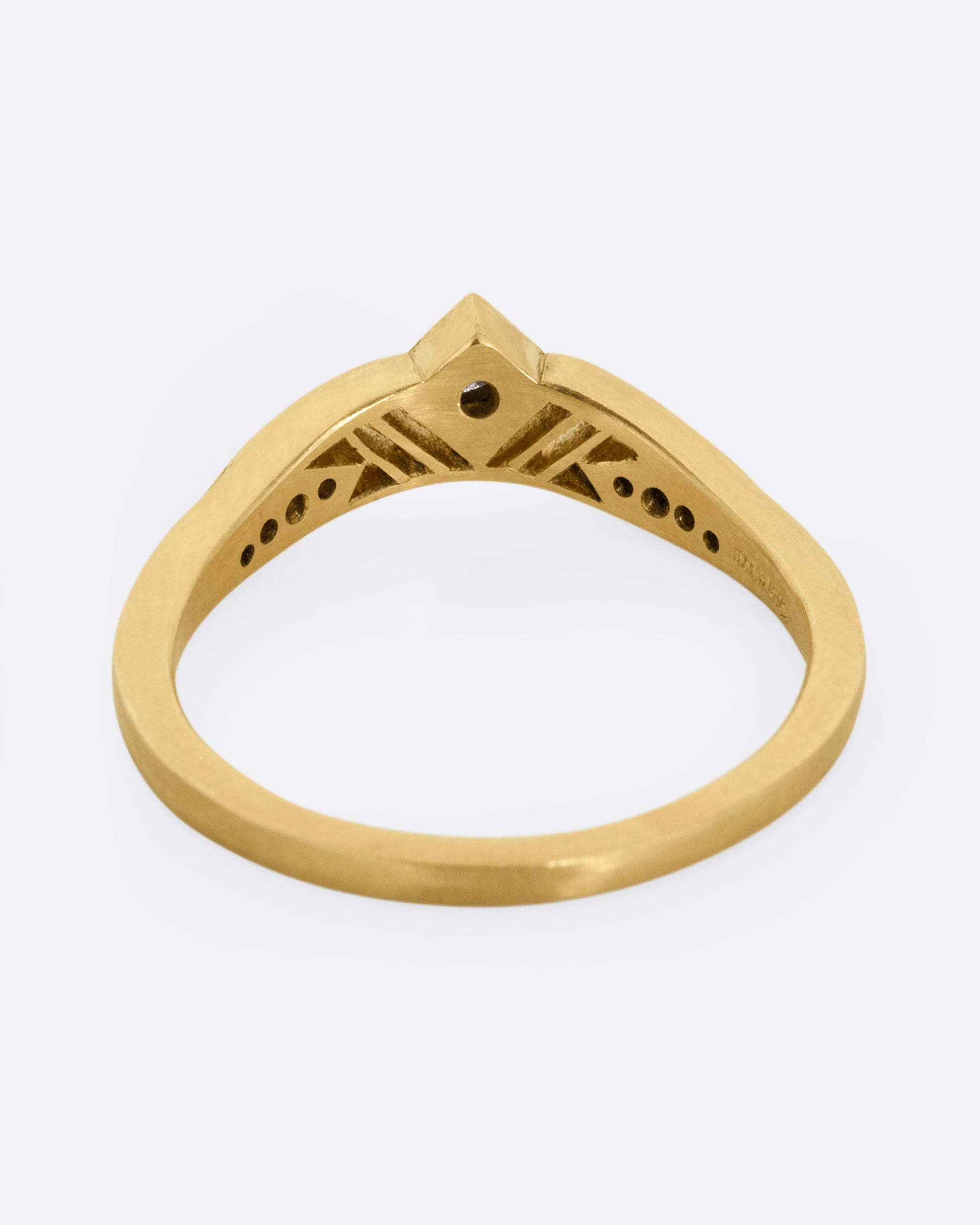 A subtly arched yellow gold ring with a diamond peak at the center flanked by graduated diamonds and cutouts. Shown from the back.