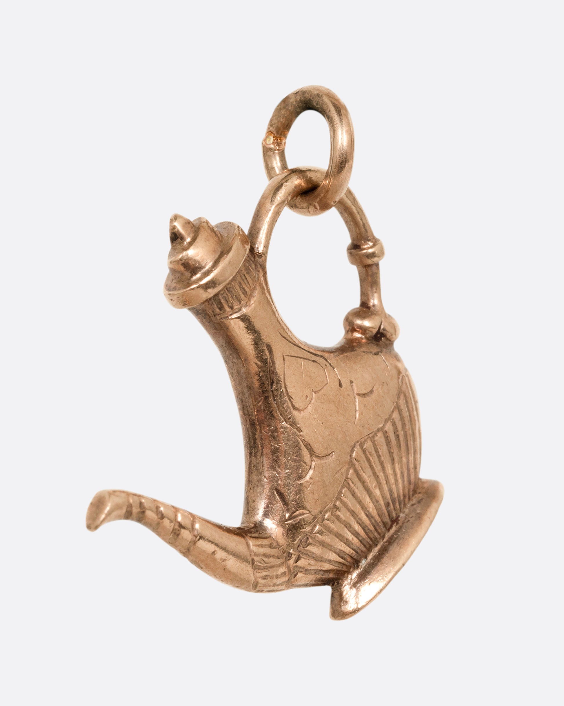 A yellow gold oil lamp charm. Shown from the side.