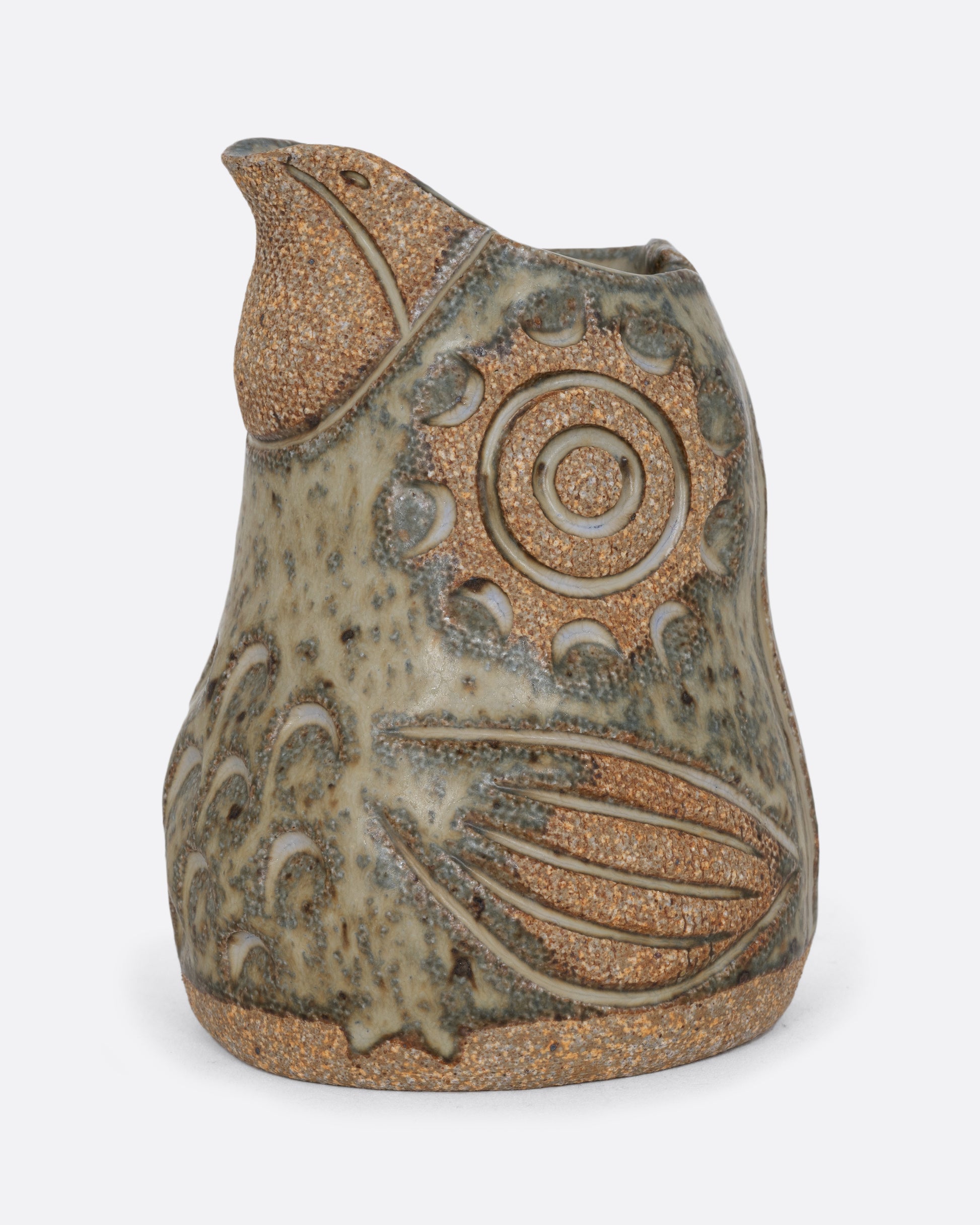 A spotted bird shaped creamer. Shown from the side.