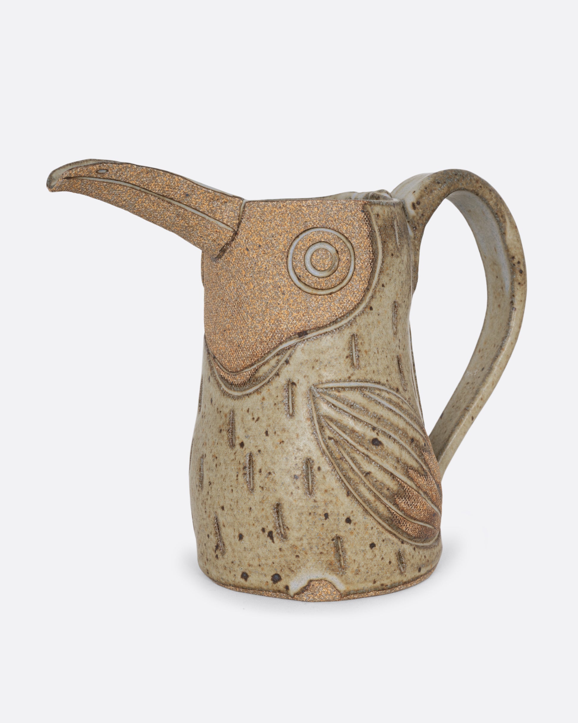 A toucan shaped pitcher with a handle. Shown from the side.