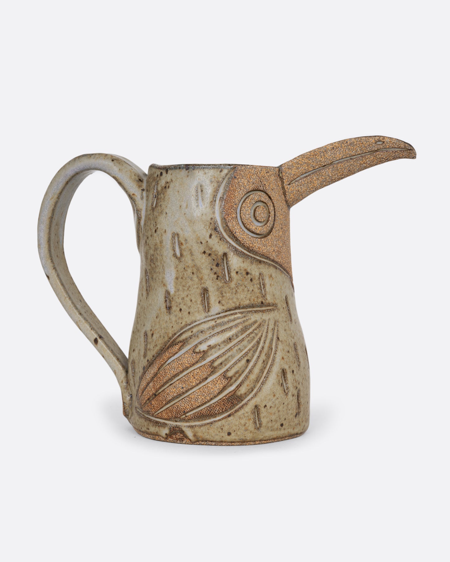 A toucan shaped pitcher with a handle. Shown from the side.