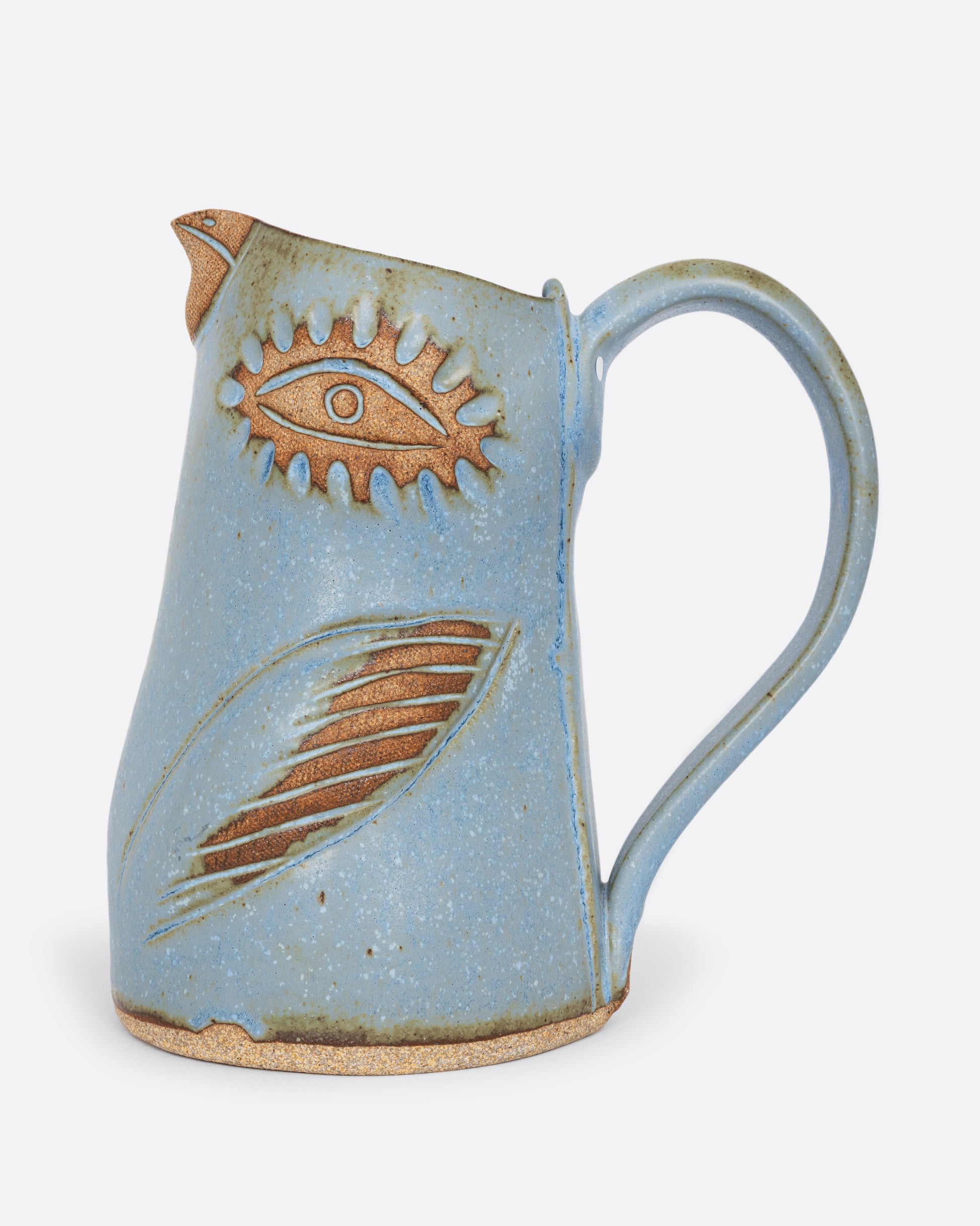 A blue bird shaped pitcher with a handle. Shown from the side.