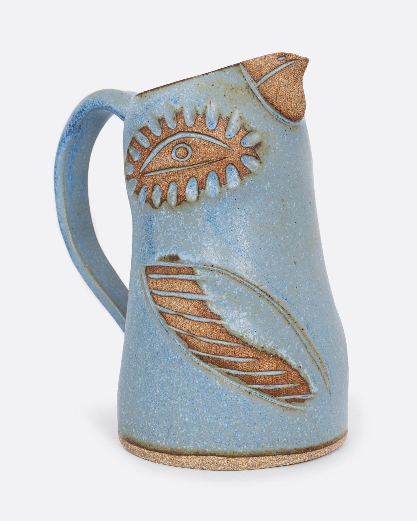 A blue bird shaped pitcher with a handle. Shown from the side.