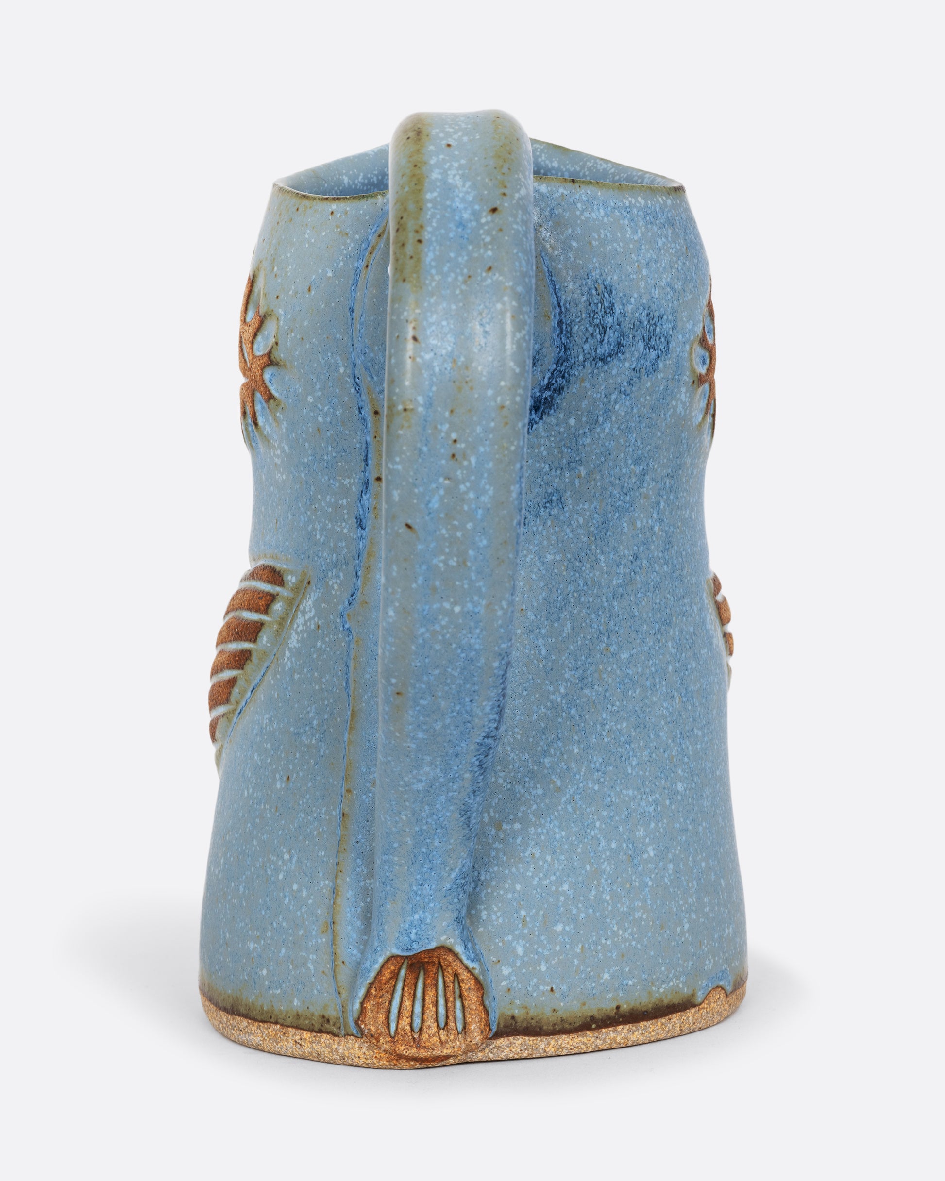 A blue bird shaped pitcher with a handle. Shown from the back.