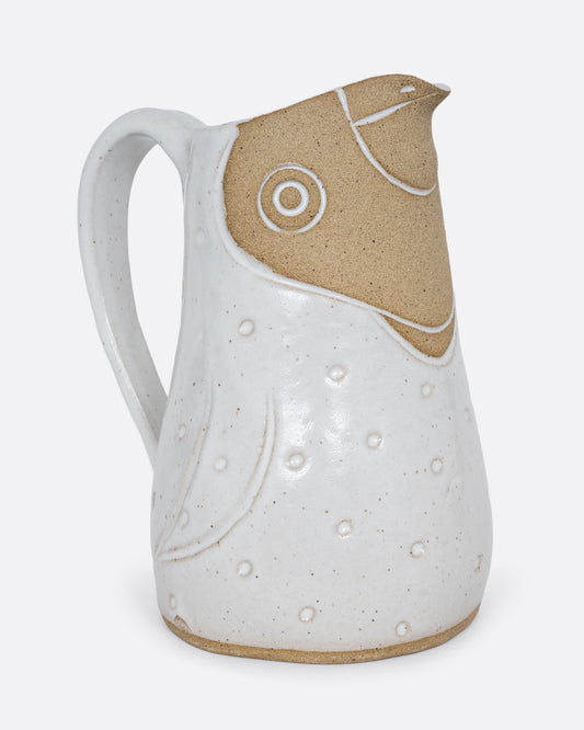 A white bird shaped pitcher with a handle. Shown from the side.