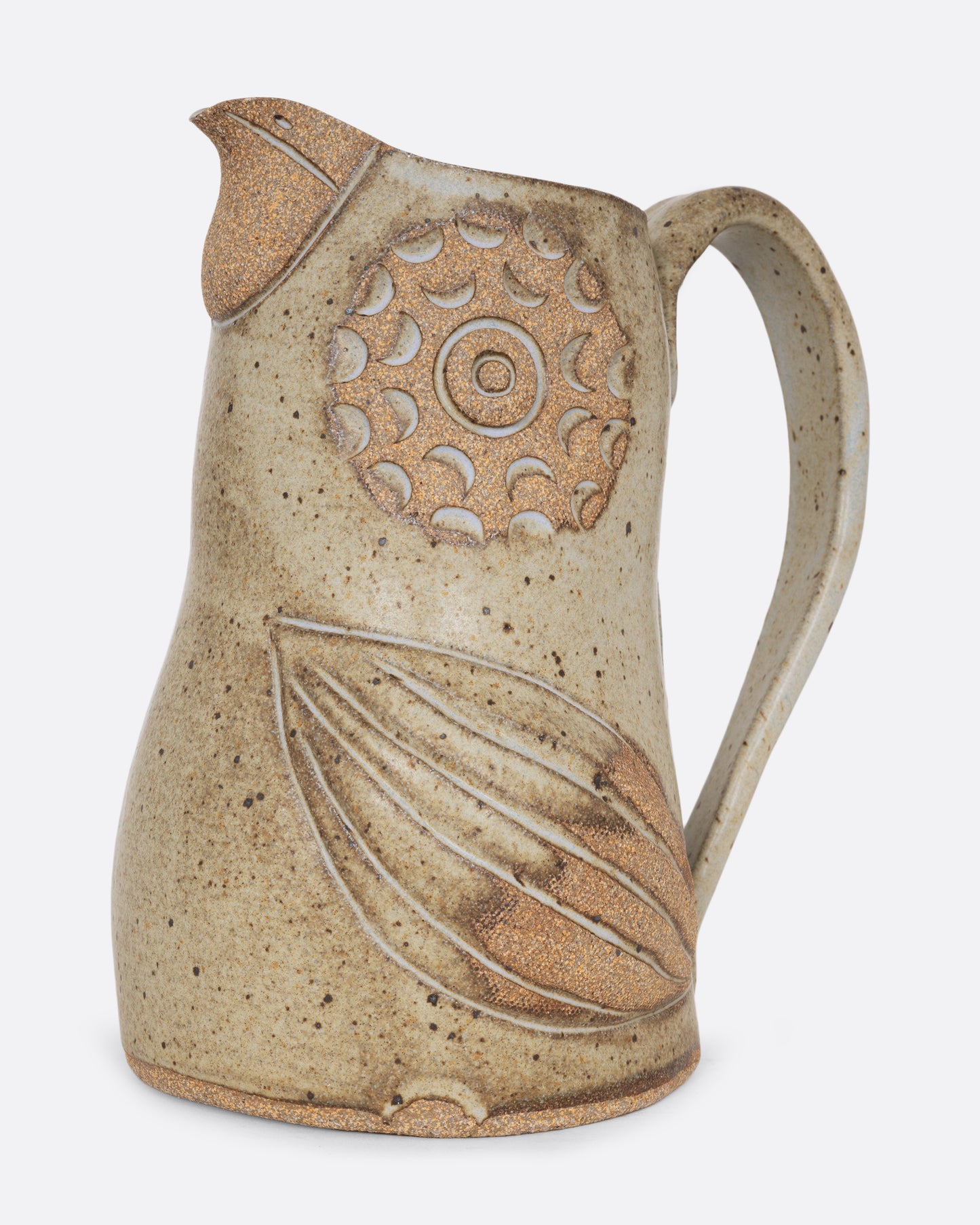 A bird shaped pitcher with a handle. Shown from the side.