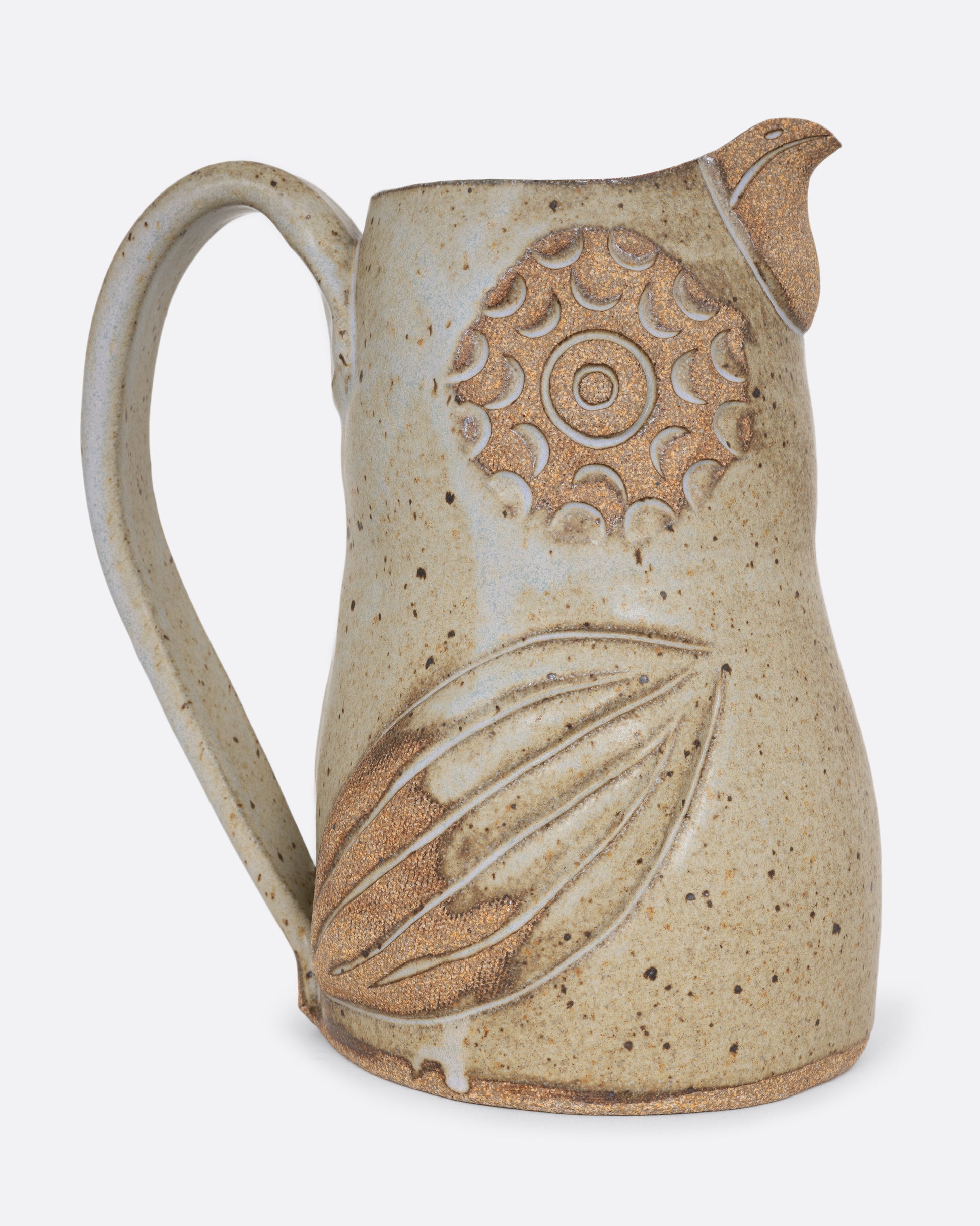 A bird shaped pitcher with a handle. Shown from the side.