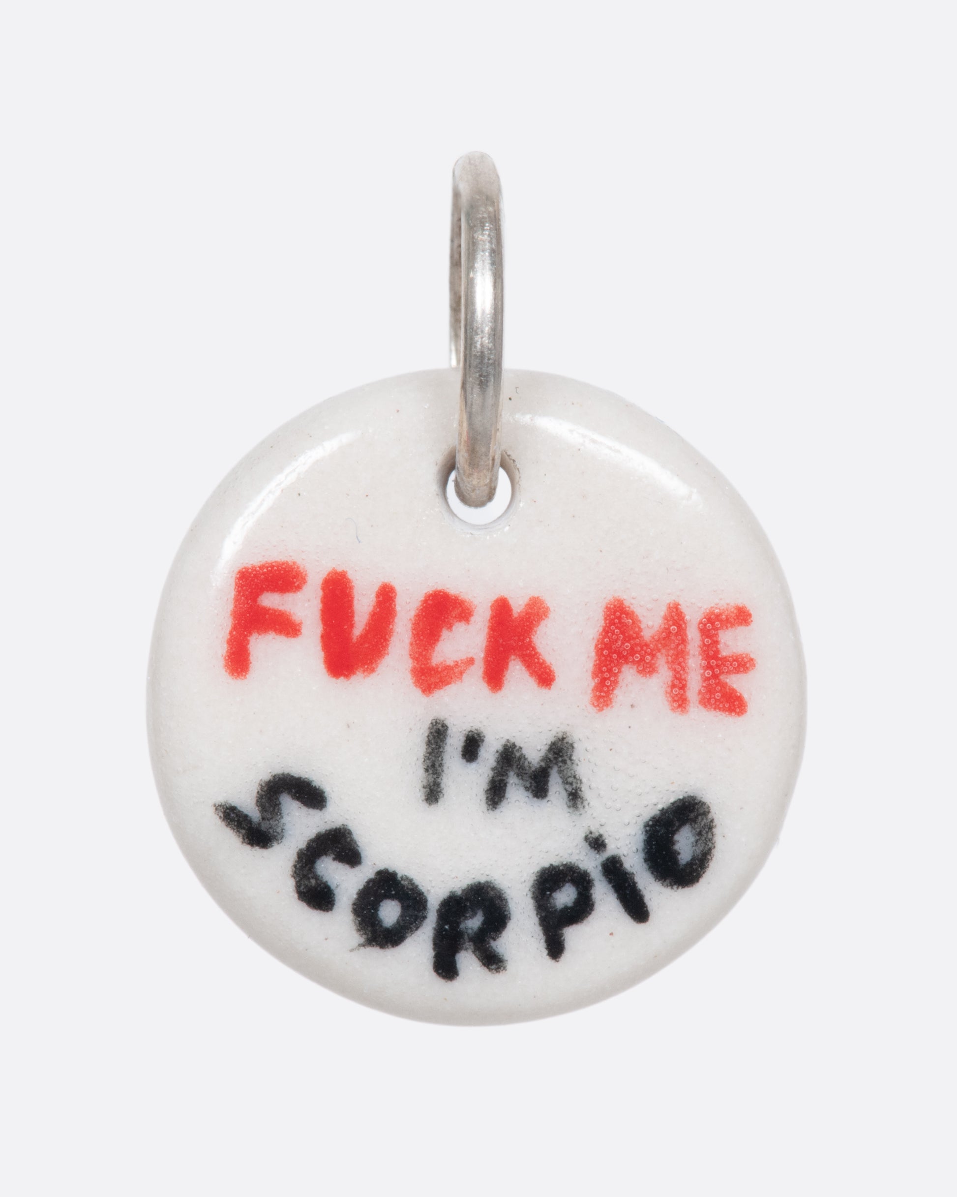 A handmade and painted porcelain zodiac disc charm with a sterling silver bail, featuring a sex position specific to each zodiac.