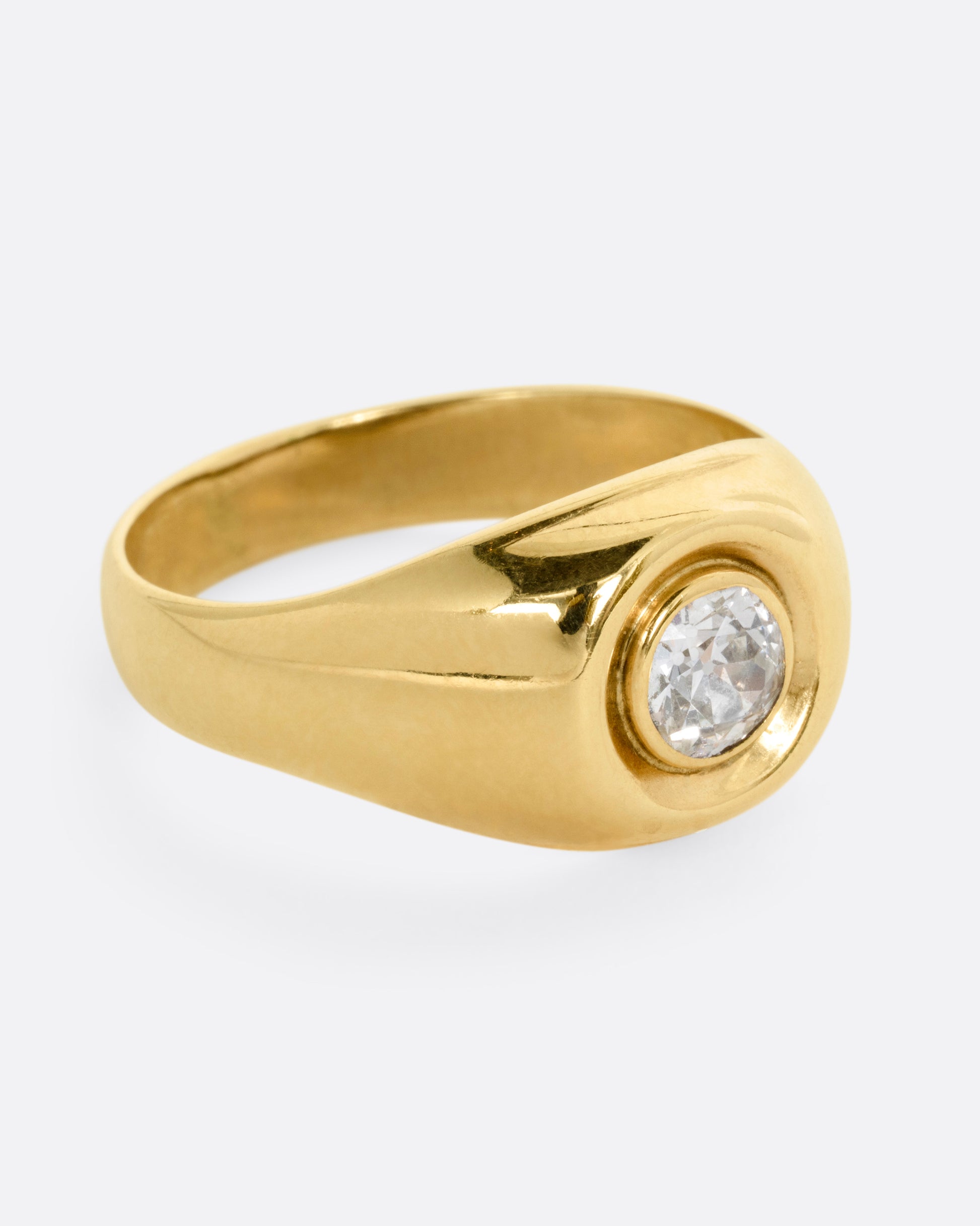A yellow gold ring with a bezel set Old European Cut diamond. Shown from the side.