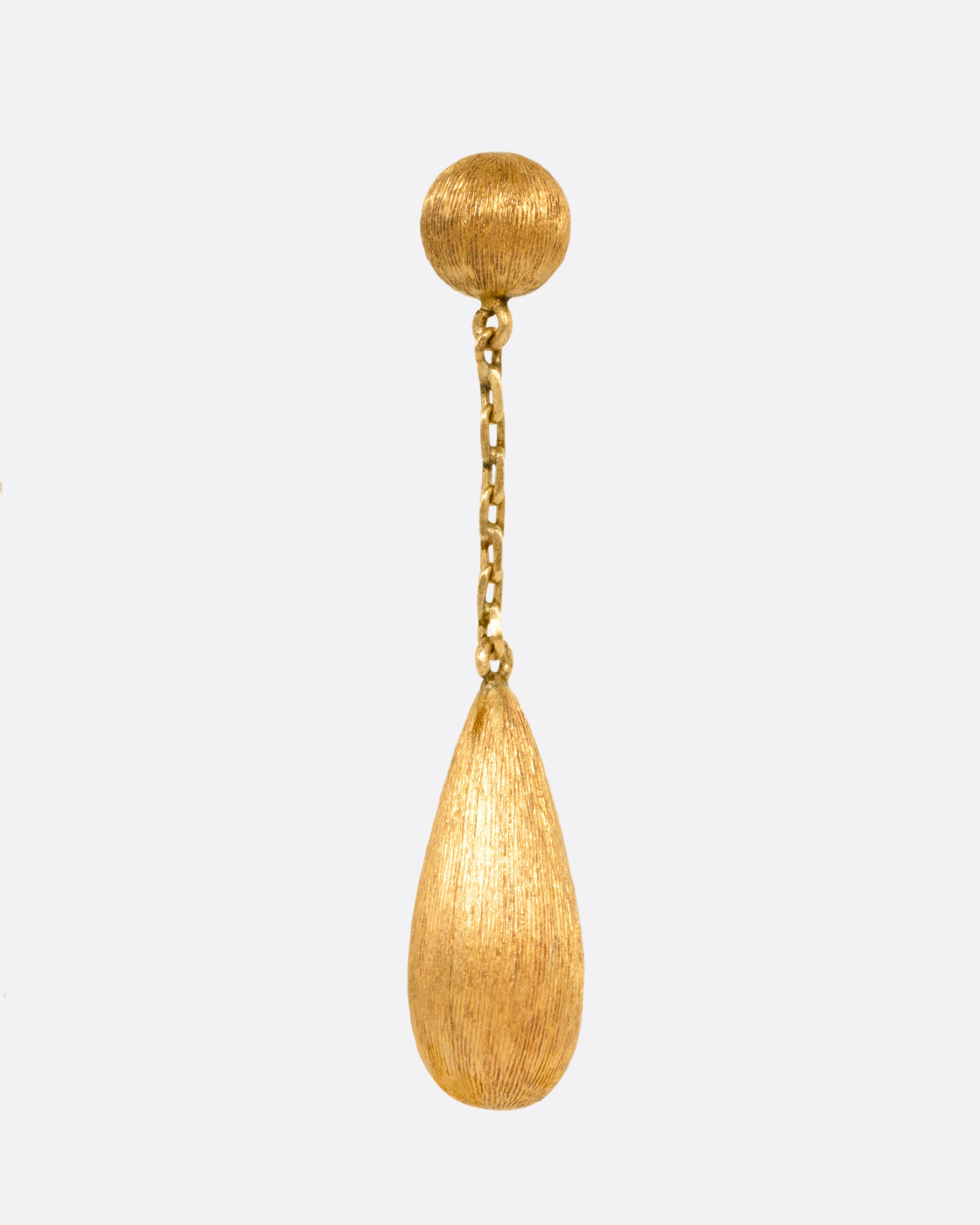 A yellow gold teardrop shaped earring, shown from the front.