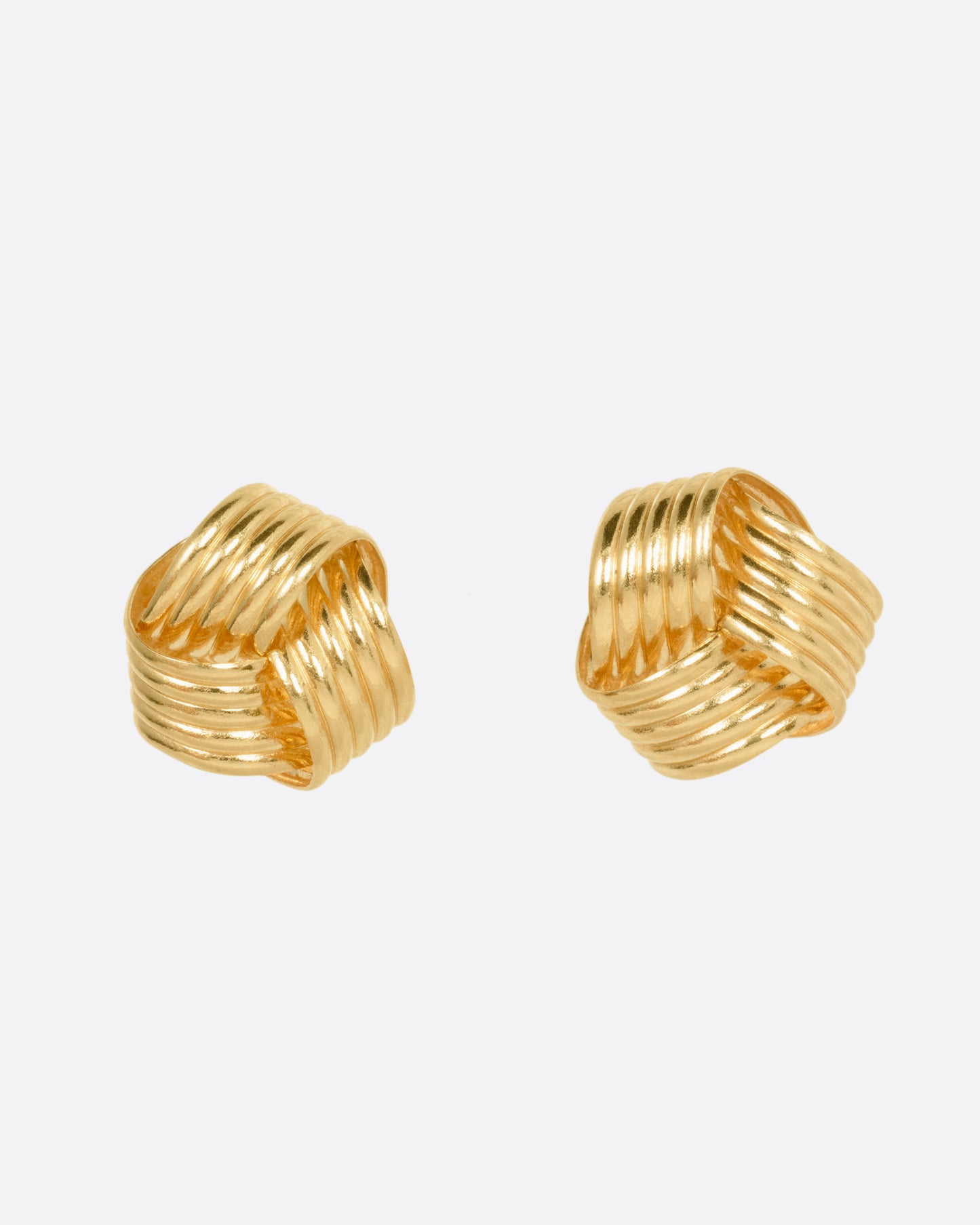 A pair of knot shaped yellow gold stud earrings, shown from the front.