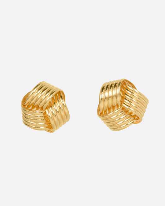 A pair of knot shaped yellow gold stud earrings, shown from the front.