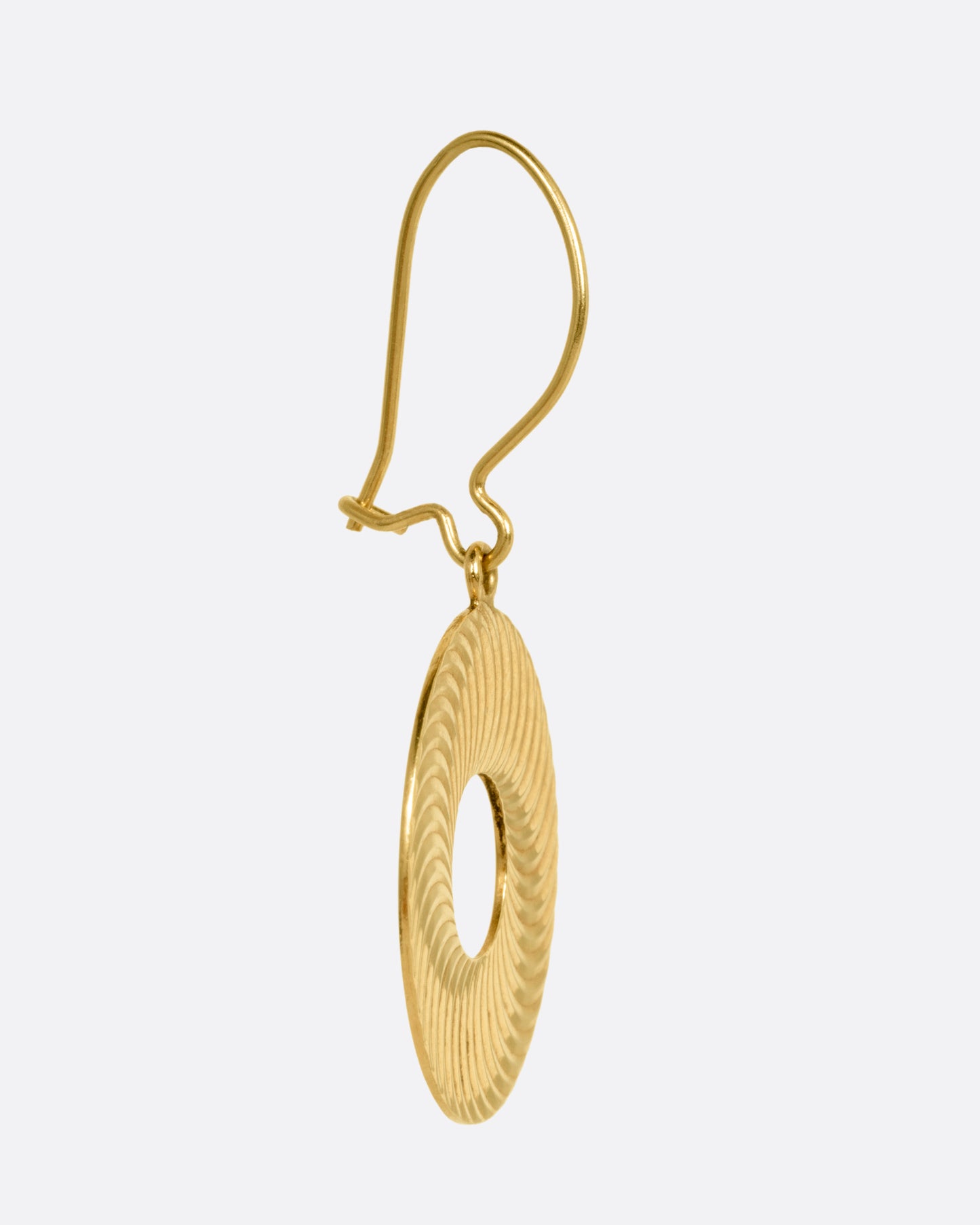 A round yellow gold drop earring with an open center and an illusional pattern, shown from the side.