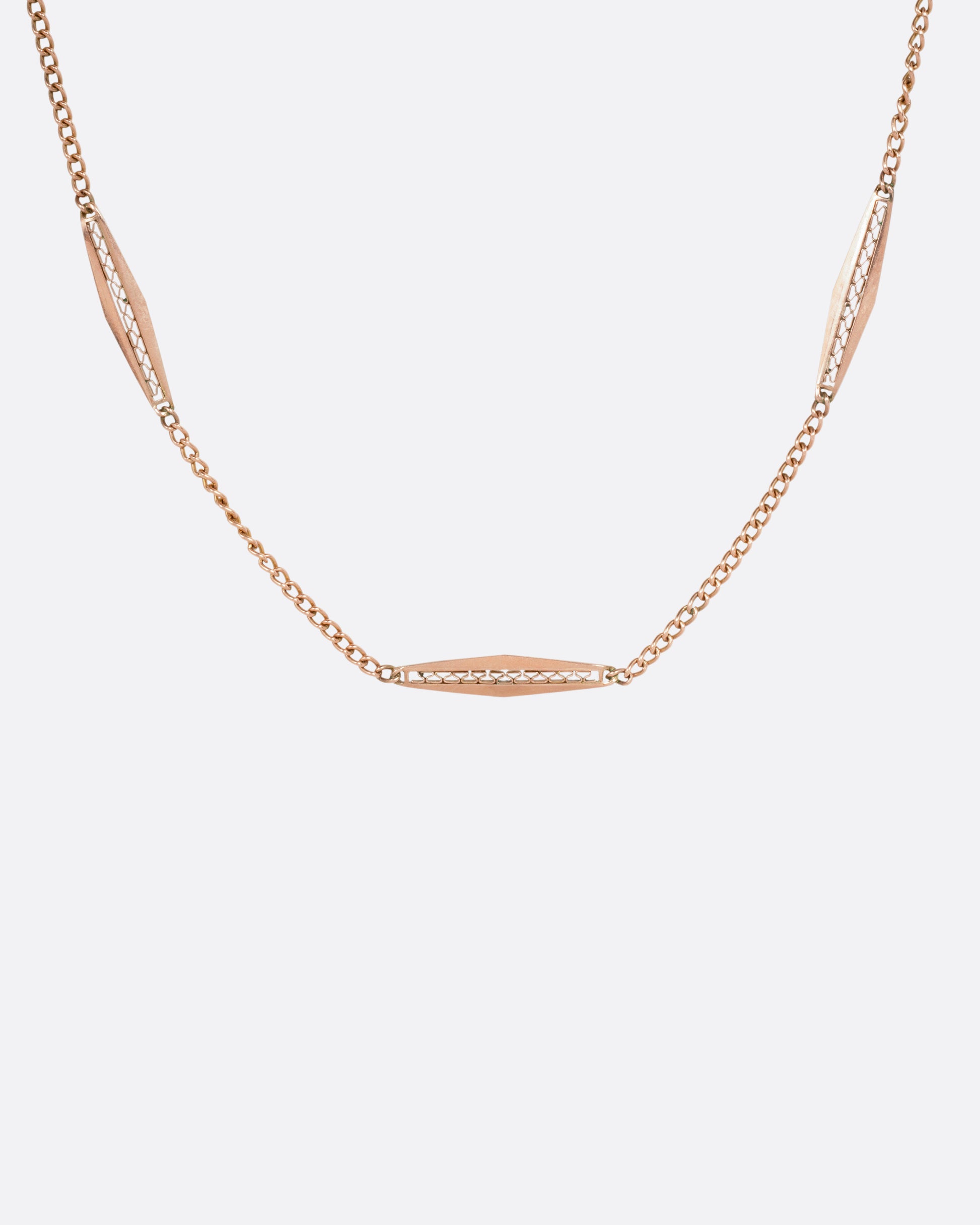 A rose gold bar link necklace shown from the front.