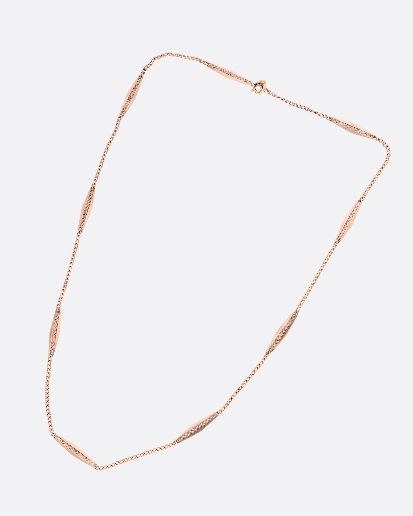 A rose gold bar link necklace shown from the front.