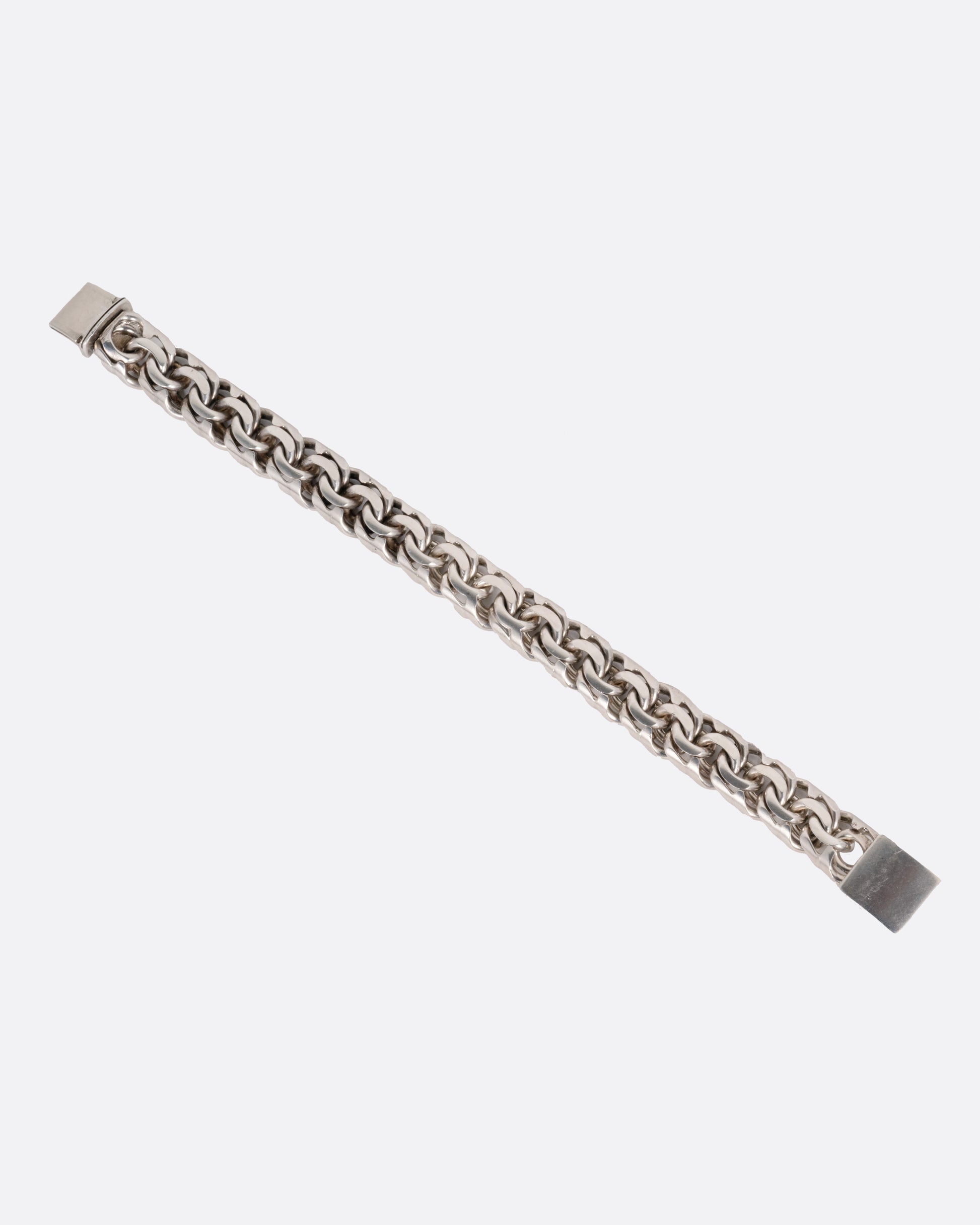 A silver flat double link bracelet, shown from the front.