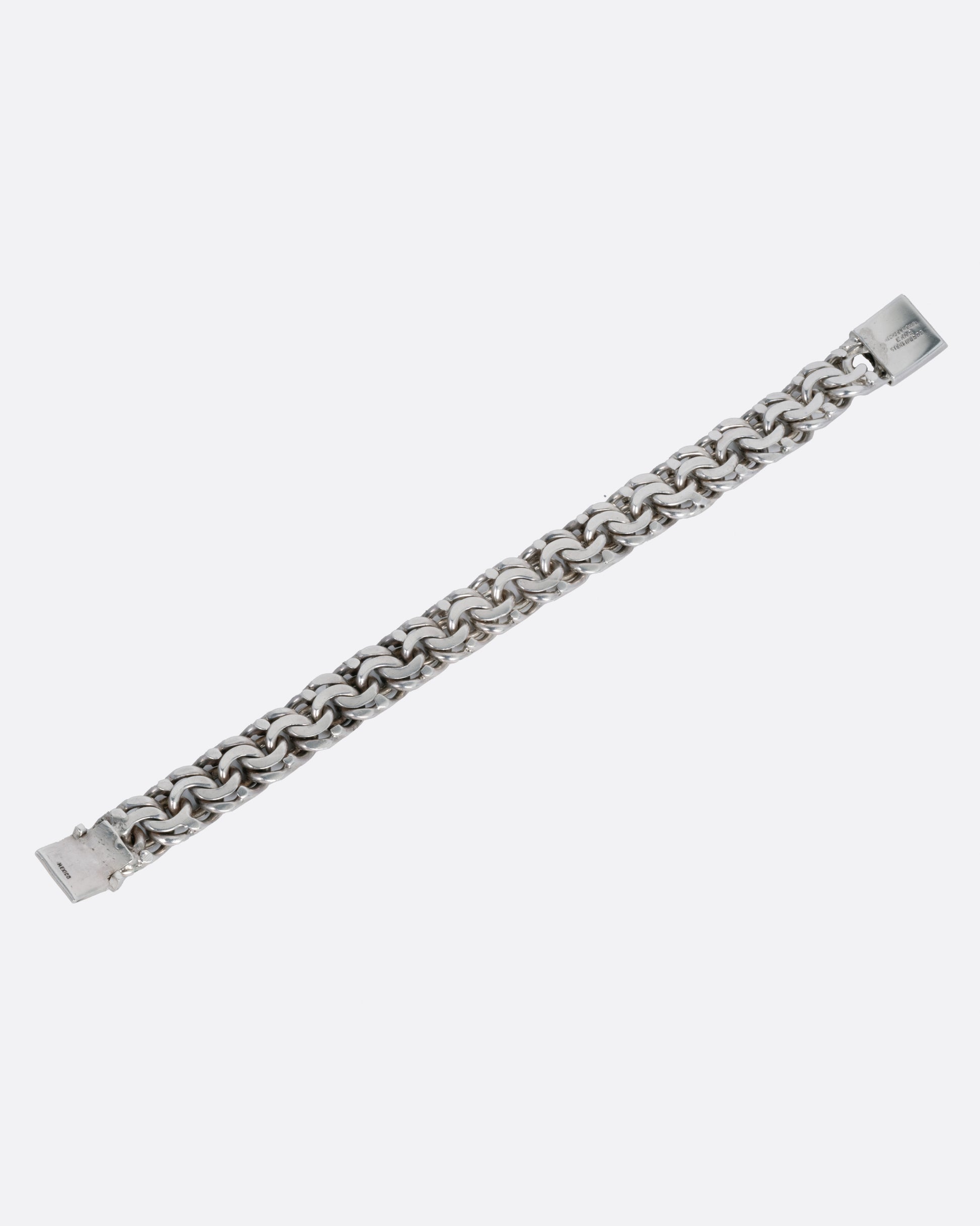 A silver flat double link bracelet, shown from the back.