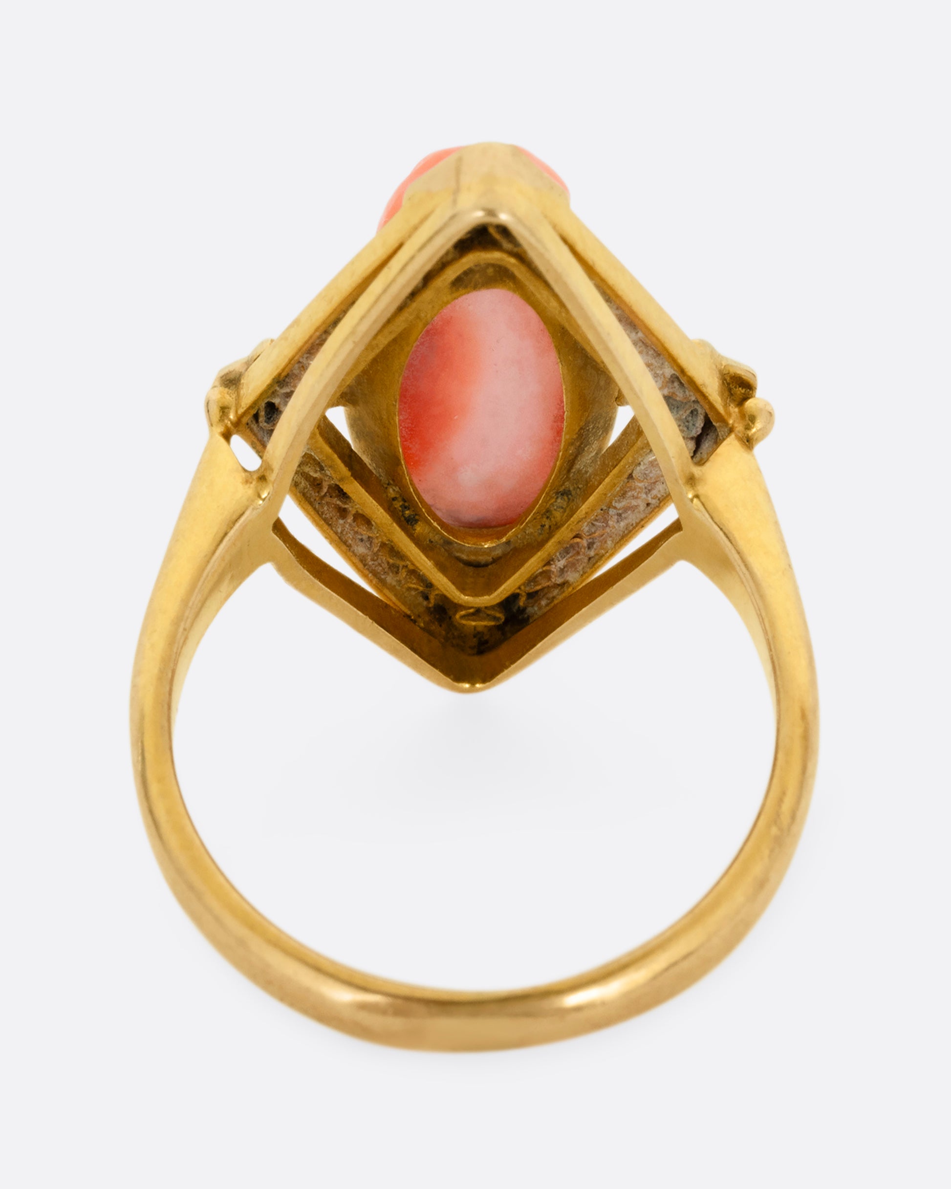 A yellow gold cameo ring with a coral carved portrait. Shown from the back.