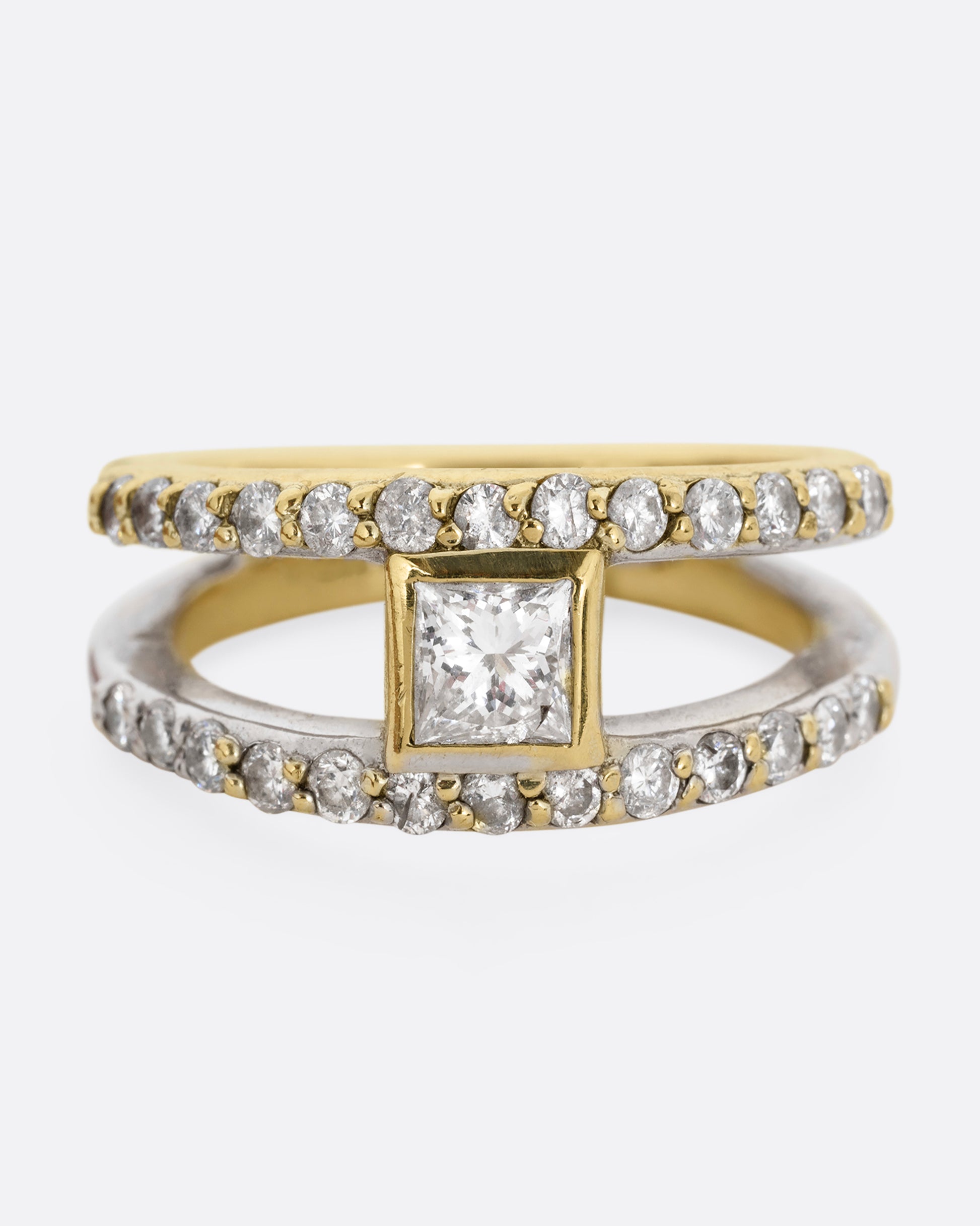 A yellow and white gold double band with pave diamonds and a center princess cut diamond. Shown from the front.