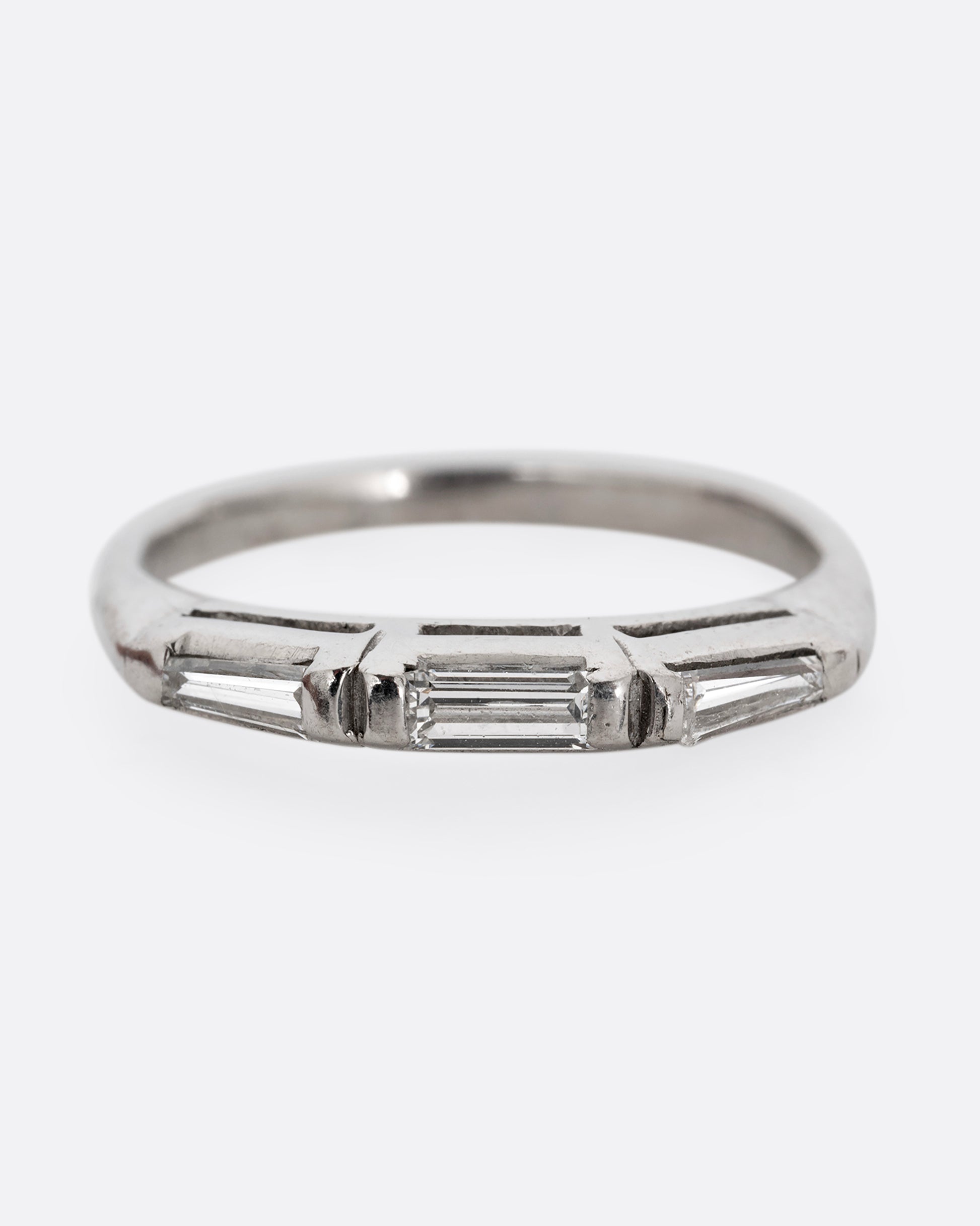 A platinum ring with three baguette diamonds. Shown from the front.