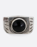A silver ring with an oval onyx. Shown from the front.