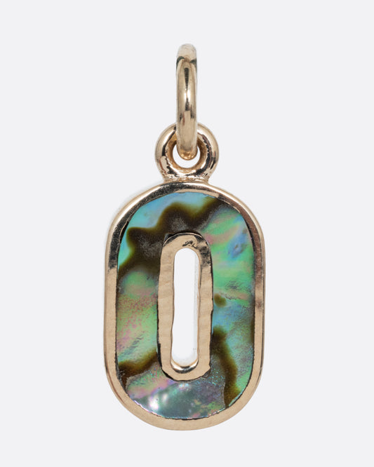 An abalone O charm set in yellow gold with a yellow gold jump ring and hoop. Shown from the front.