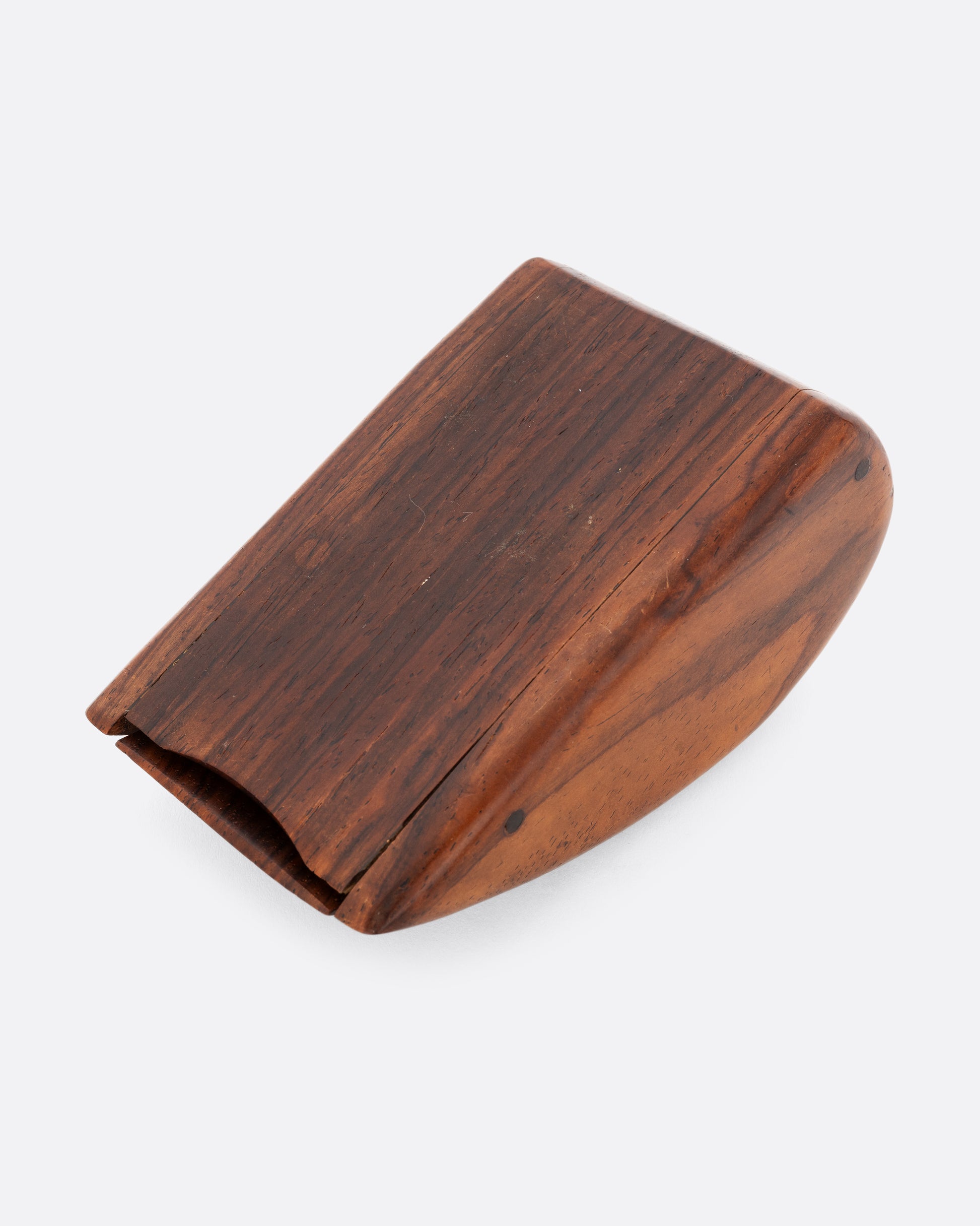 A curved wooden box shown from the bottom.