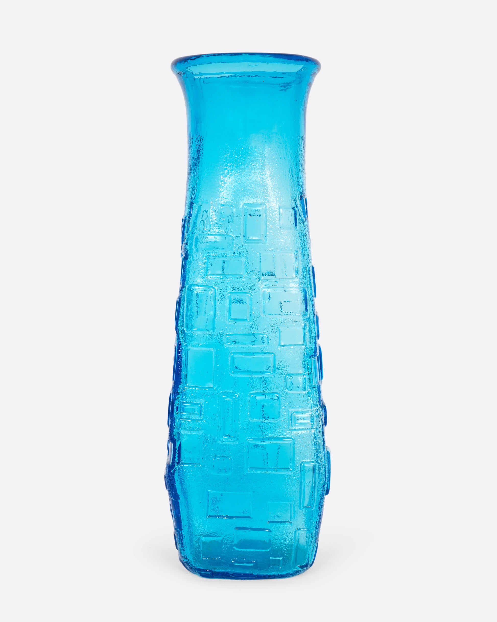  A tall cerulean glass vase with an all-over geometric pattern. Shown from the front.