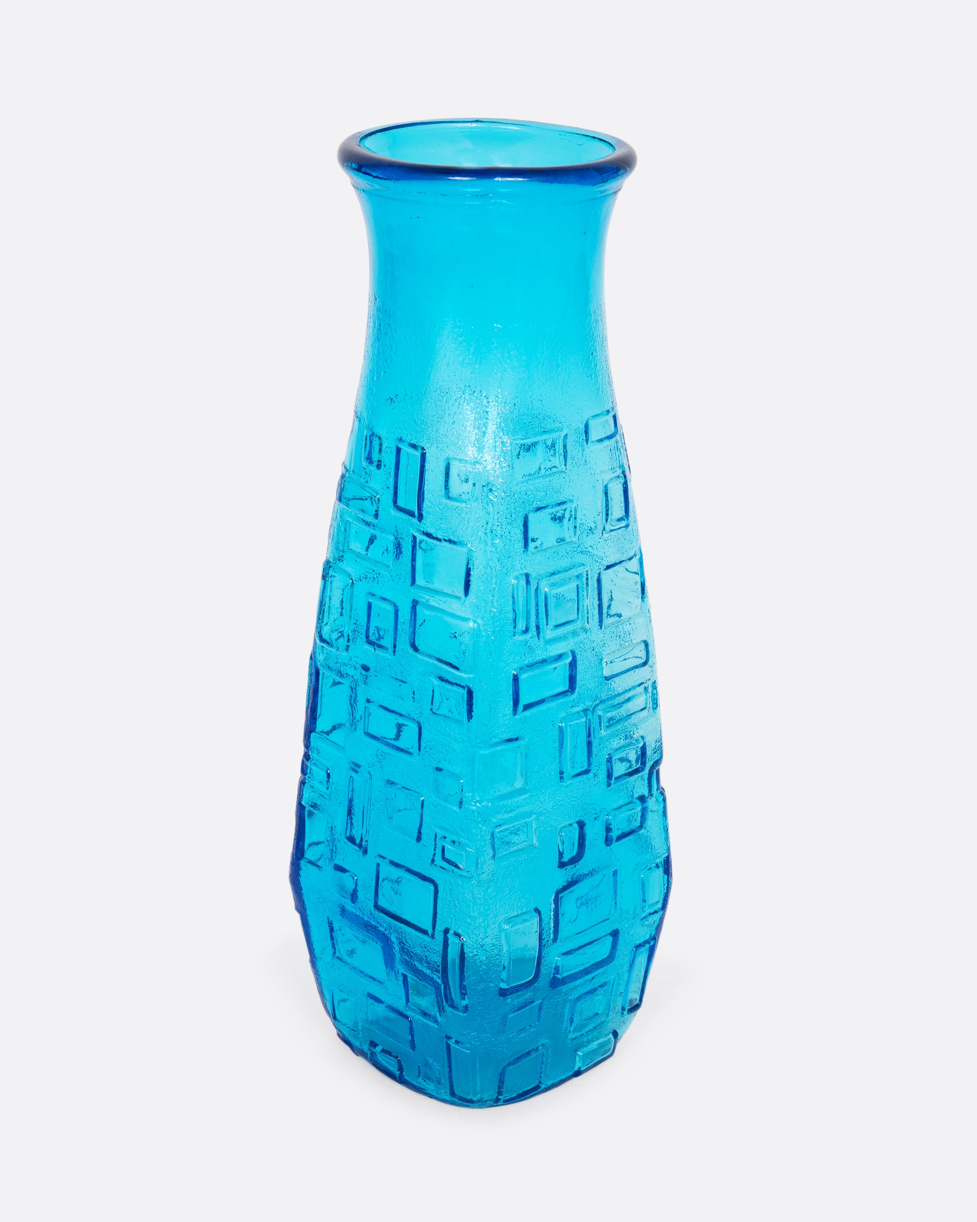  A tall cerulean glass vase with an all-over geometric pattern. Shown from the front.