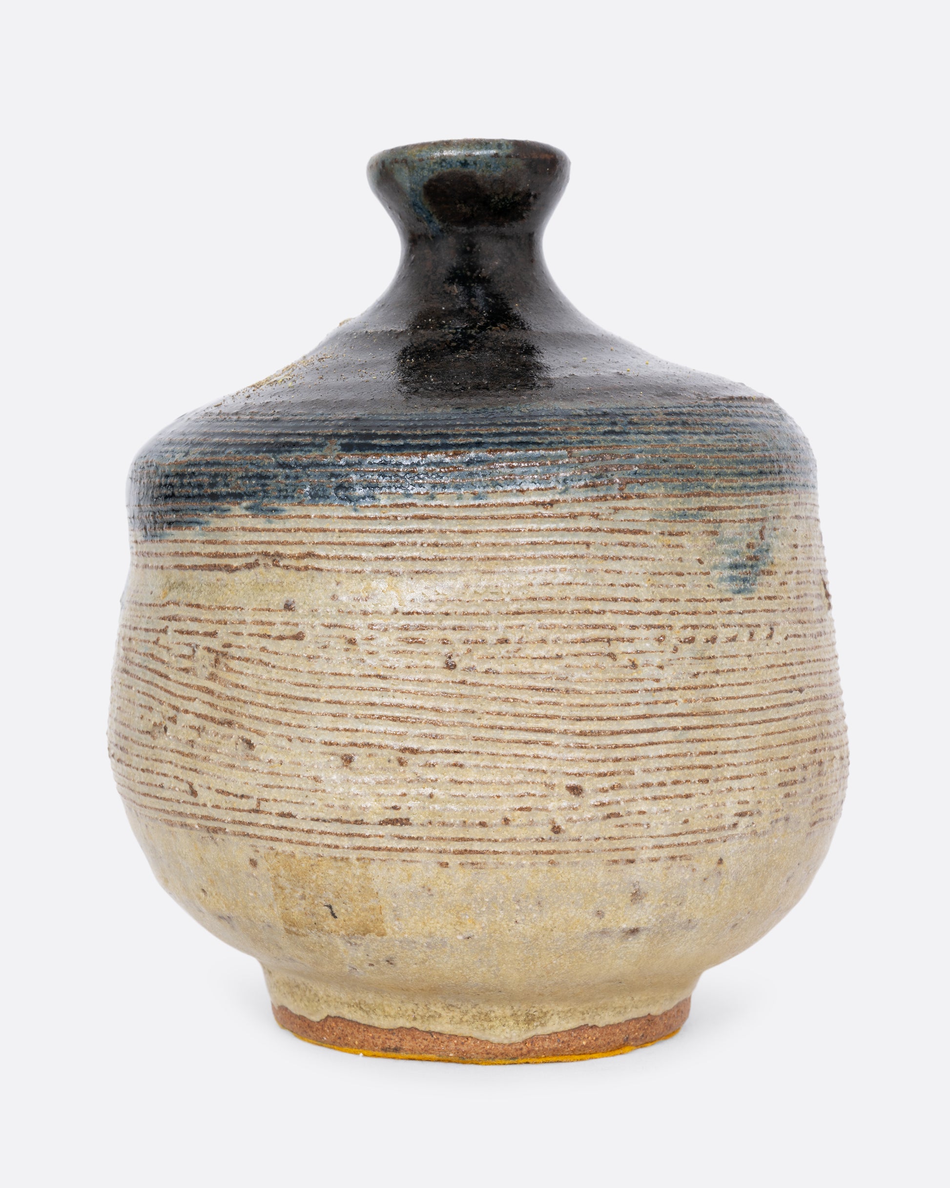 A vase with an indigo blue dipped top and ribbed texture. Shown close up from the front. 